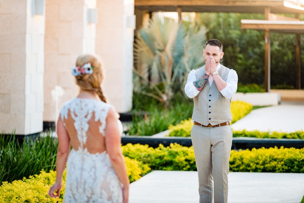 grooms hands to his face after first look with bride