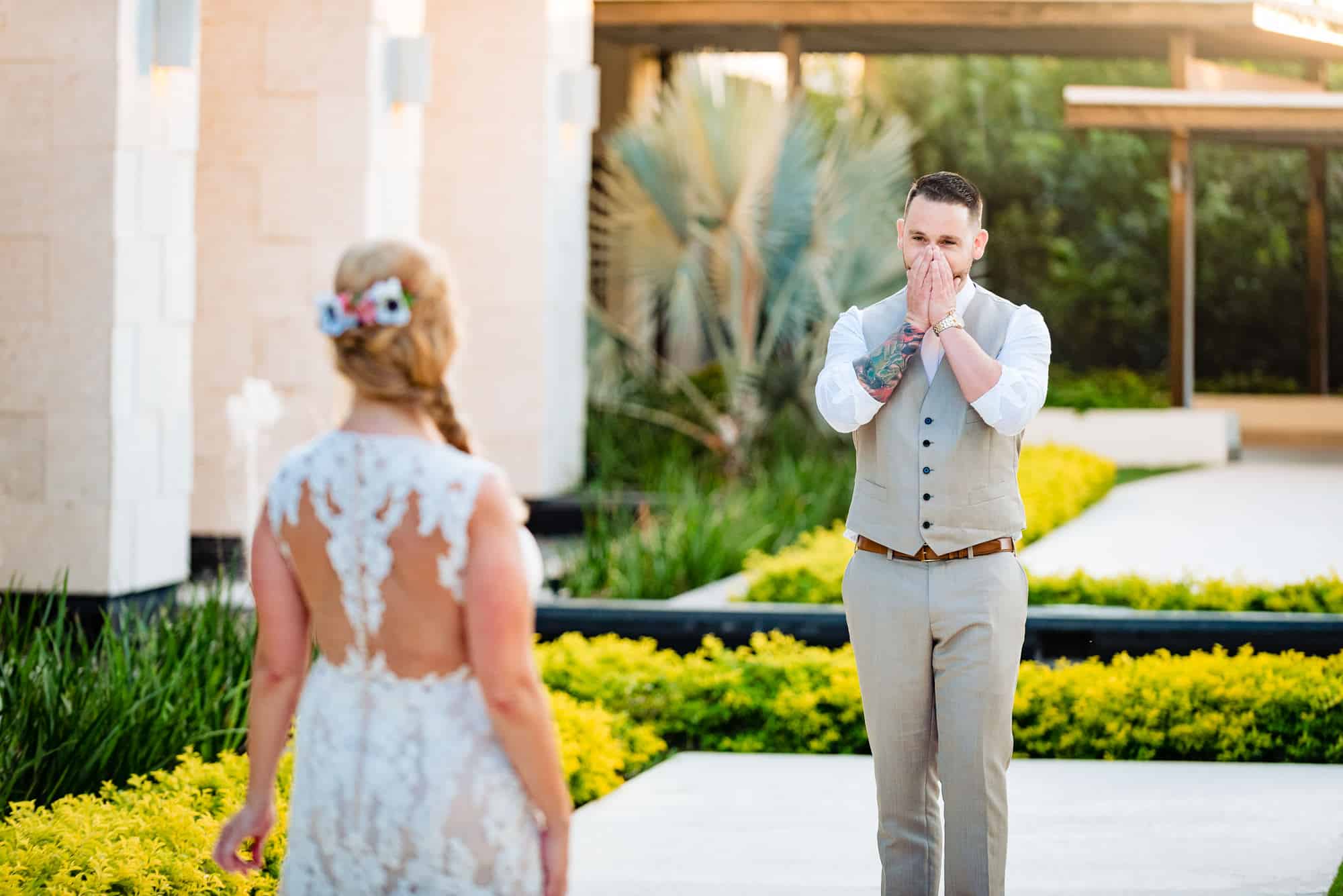 grooms hands to his face after first look with bride