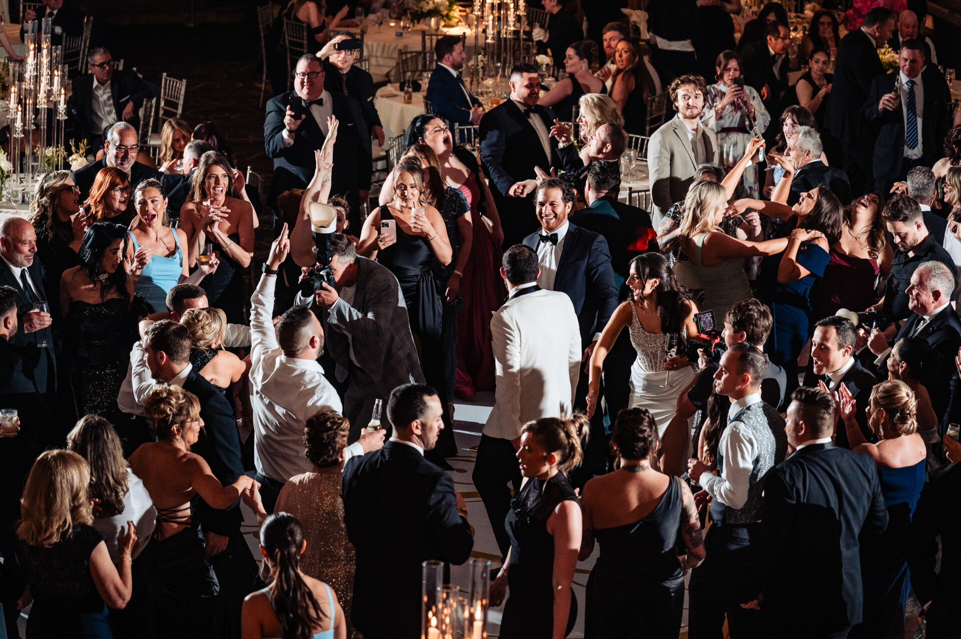 Wedding guests surrounding the couple on the ballroom dance floor during an energetic reception at The Ben.