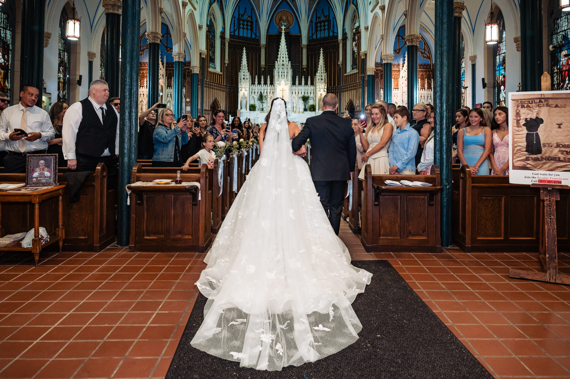 Bride walking into the church arm-in-arm with her father