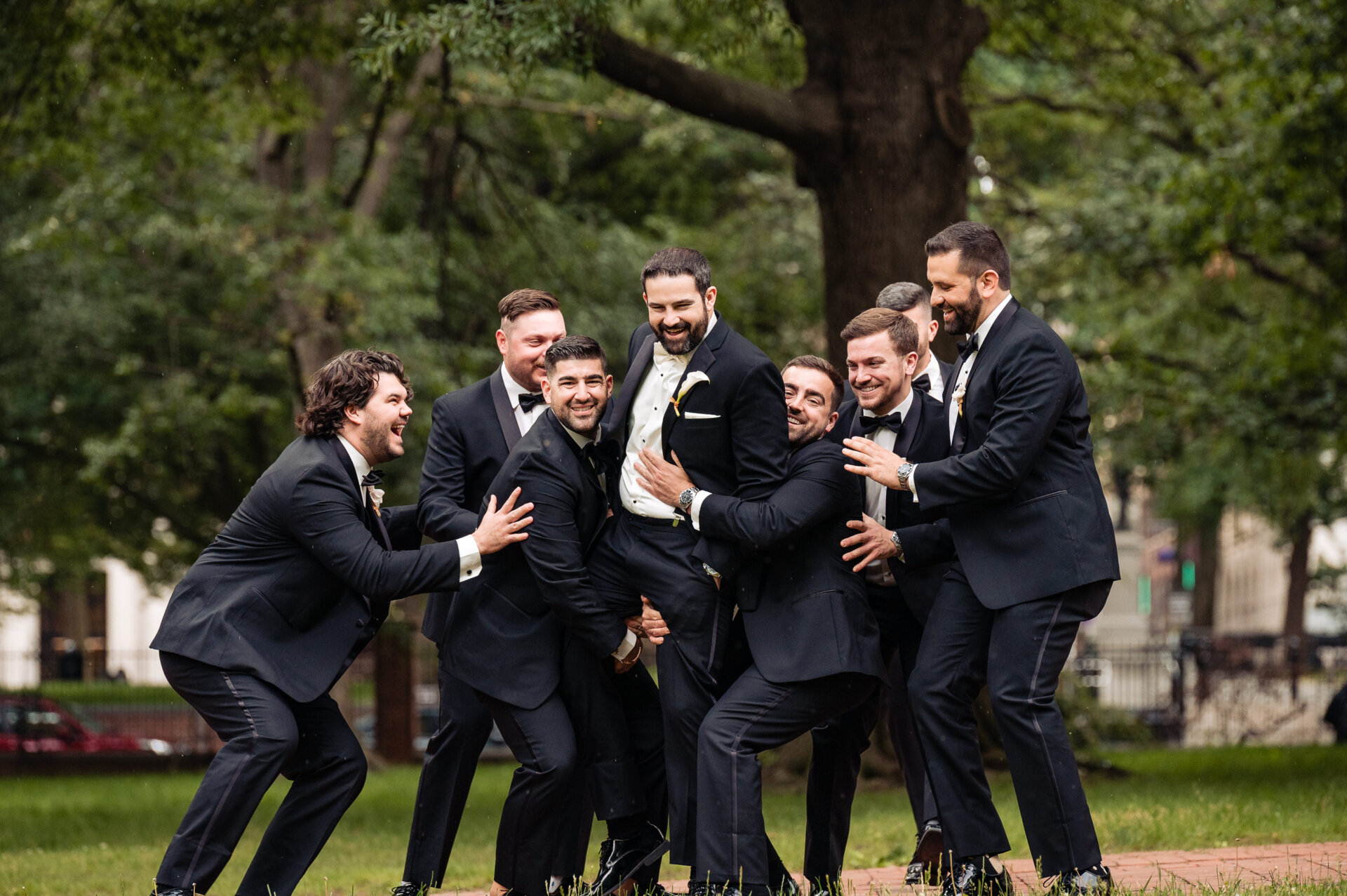 Groom poses for a fun and playful photo with his groomsmen after the ceremony.