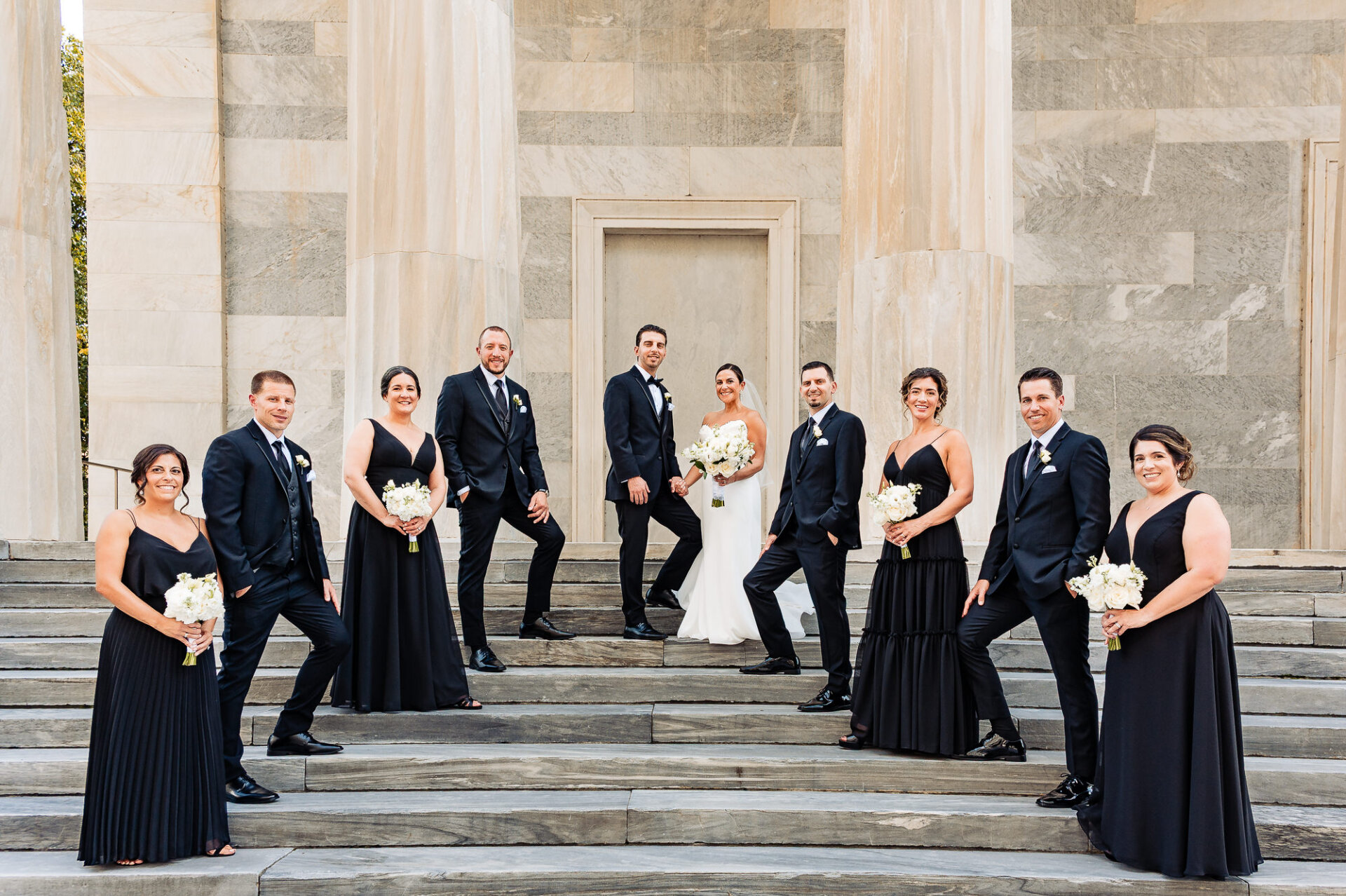 Wedding party posing on Union Trust steps with bride and groom centered