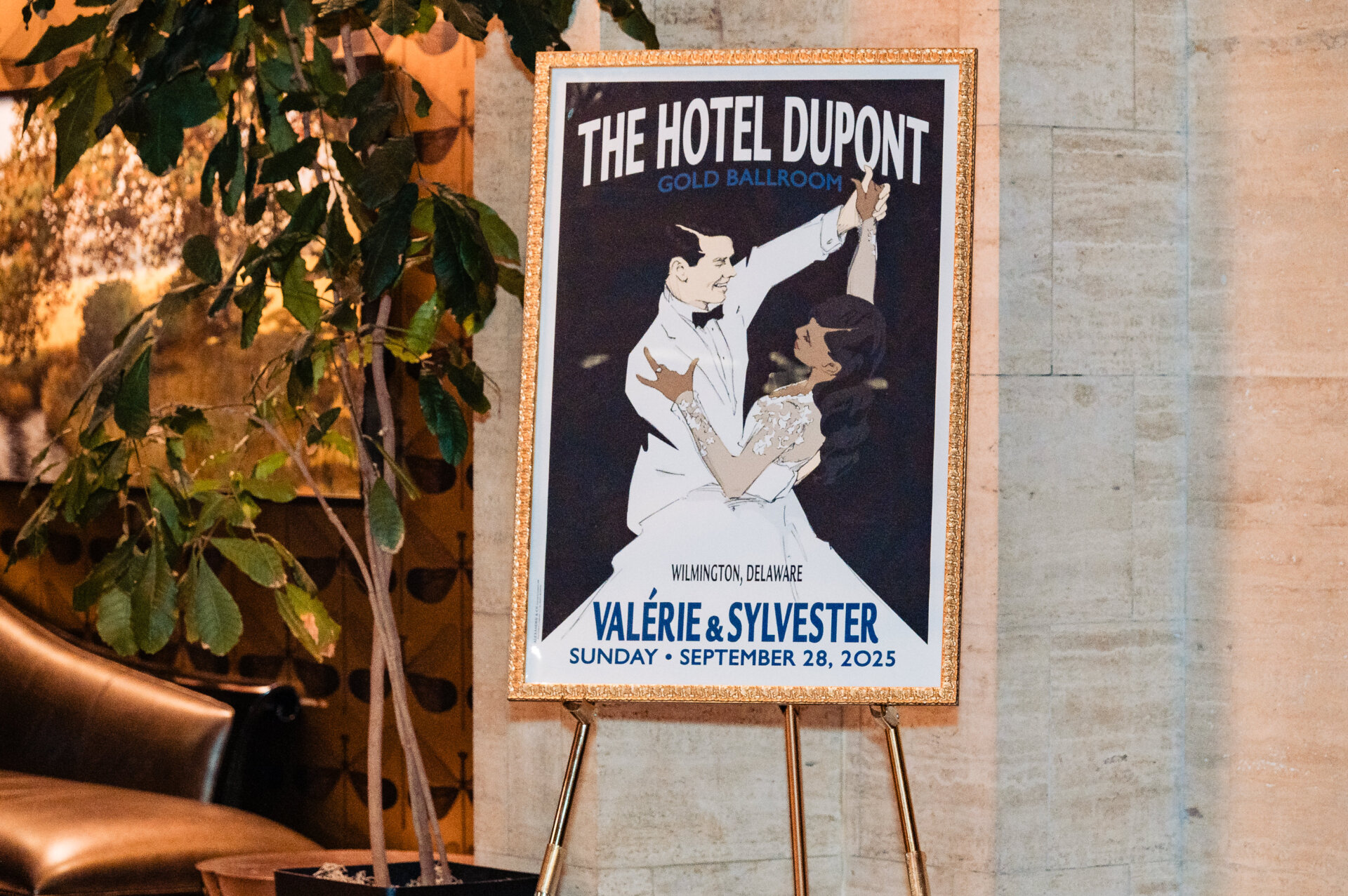 Custom wedding sign displayed at Hotel DuPont Gold Ballroom entrance with illustrated couple and wedding date.