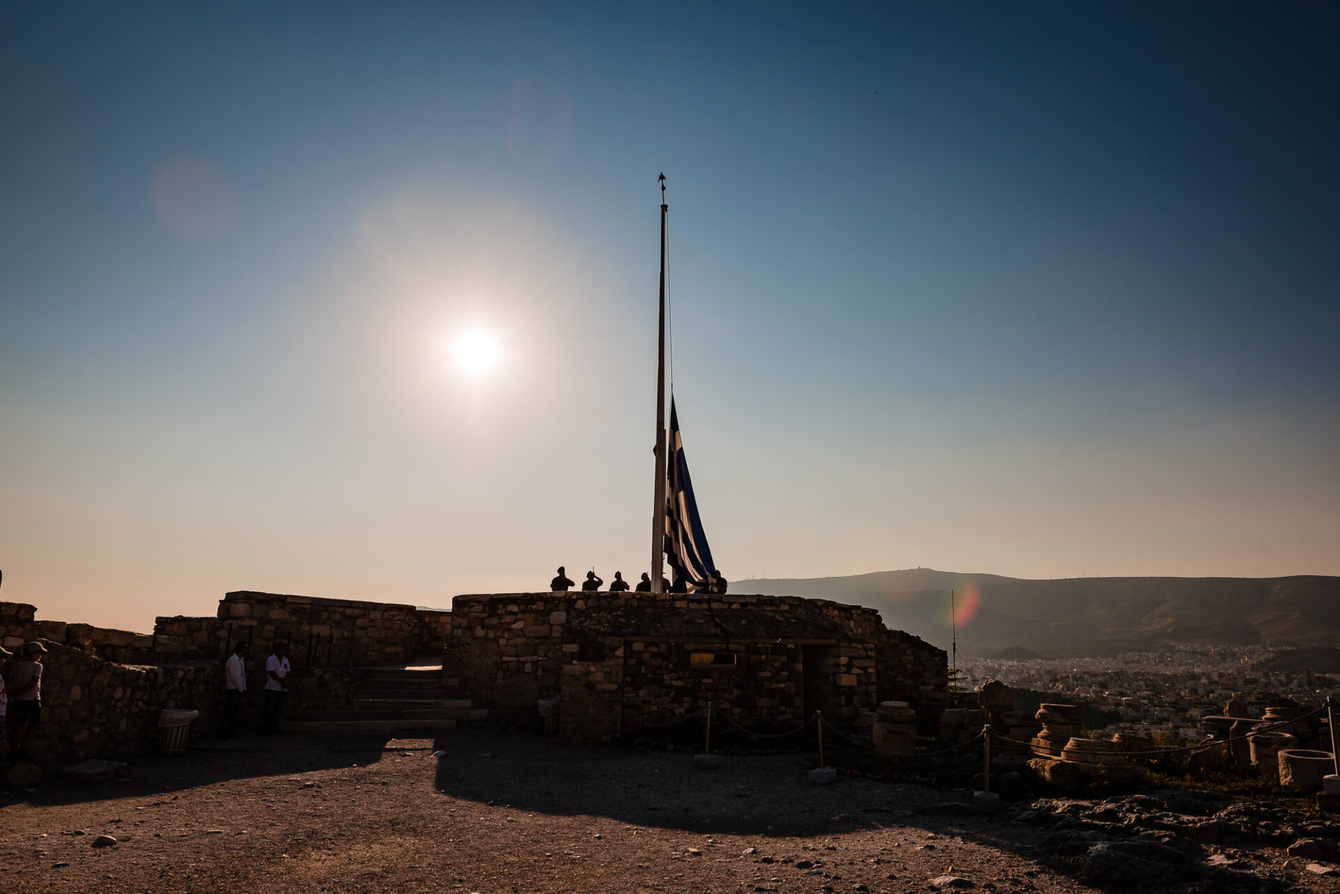 Greek army soldiers raising the national flag on Acropolis Hill.
