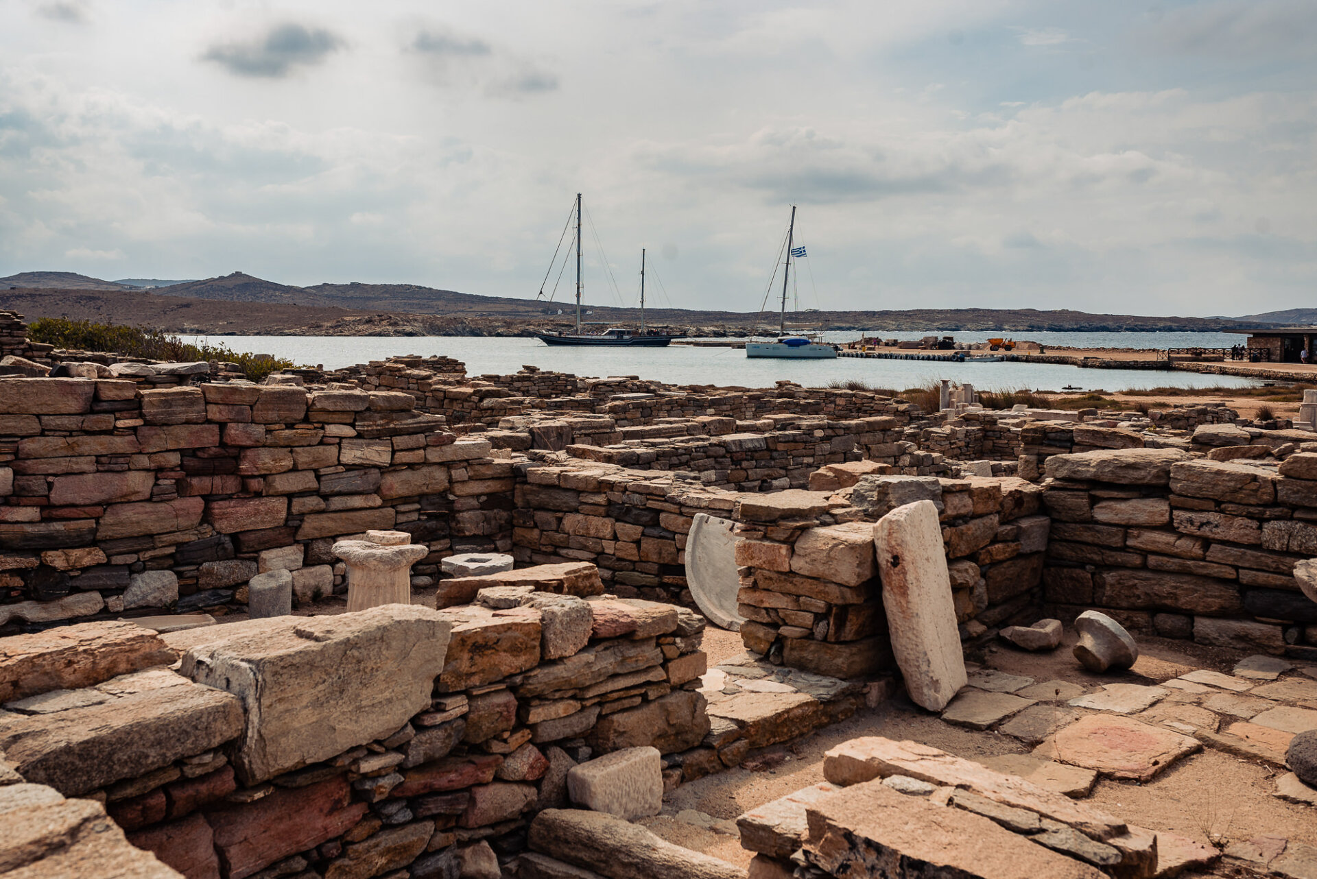 ancient archaeological ruins on Delos Island, Greece, overlooking the Aegean Sea