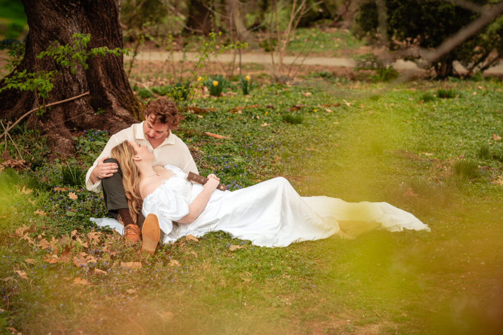 Couple relaxing on the ground under large tree during Georgetown D.C. engagement photos