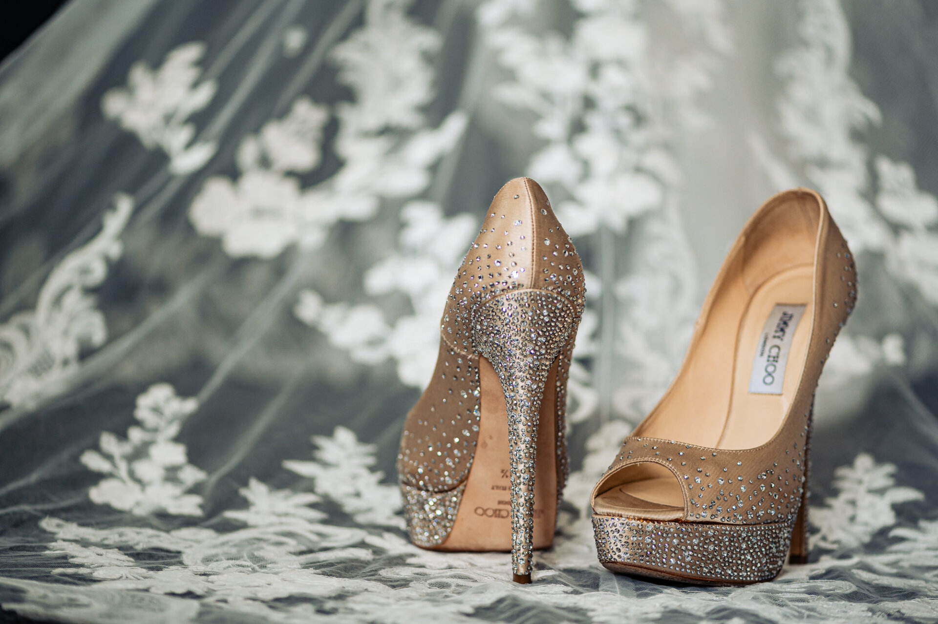 Jimmy Choo crystal-embellished bridal heels styled on lace veil details before the ceremony