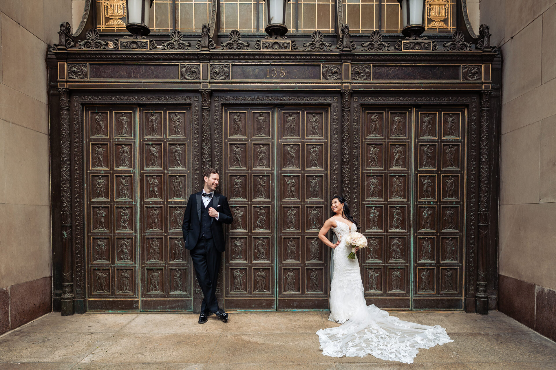Editorial couple portrait in front of Union Trust’s historic bronze entrance doors