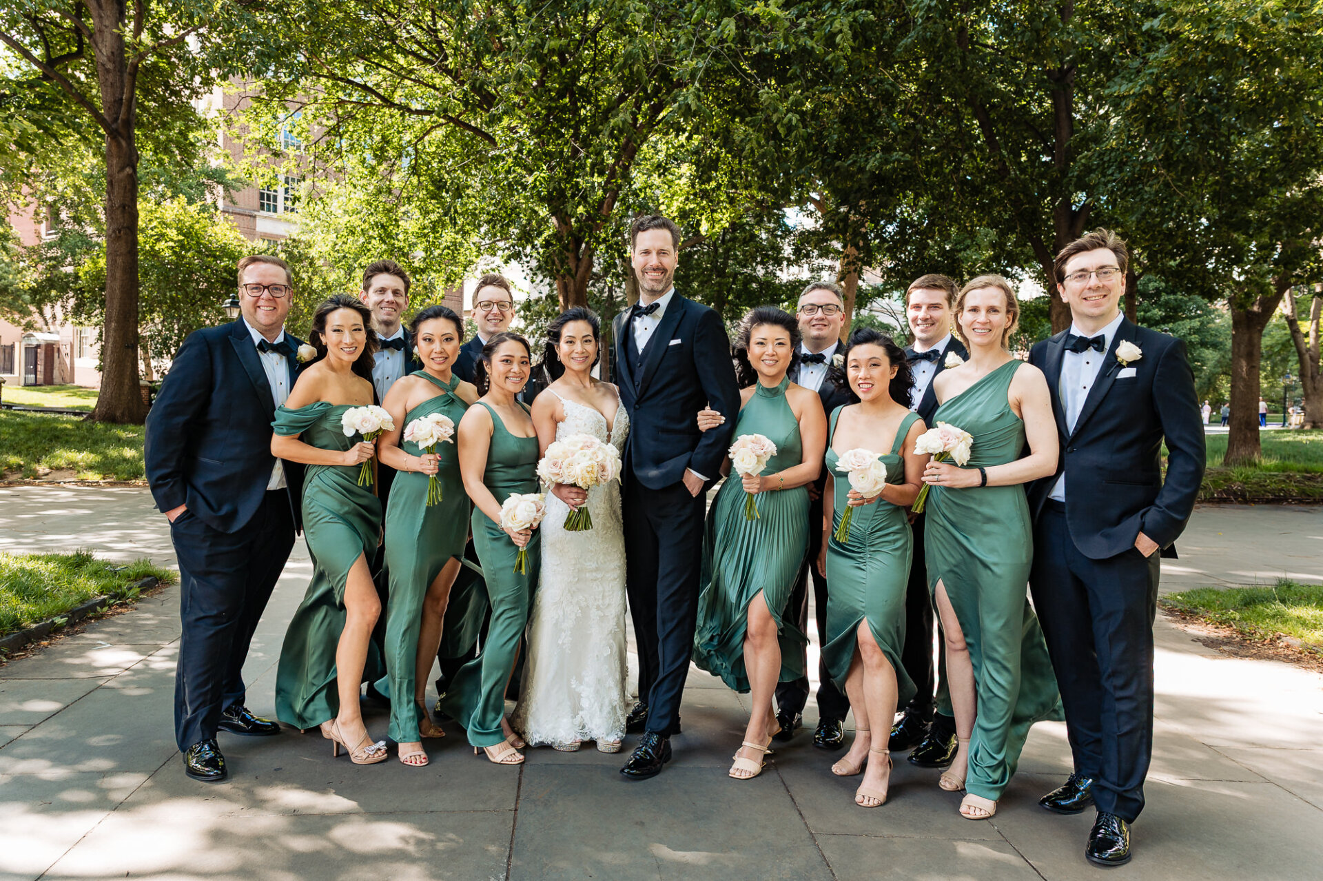 Wedding party portrait in Philadelphia with coordinated sage green bridesmaid dresses