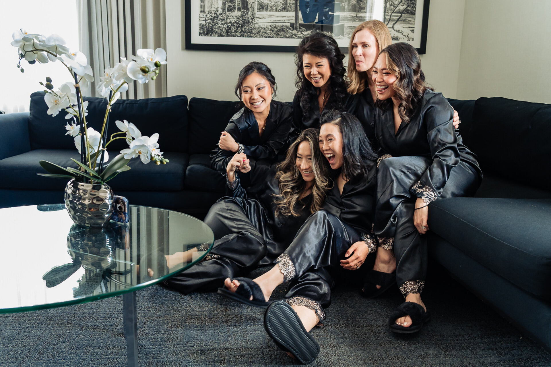Bridesmaids sharing a joyful getting-ready moment while watching a special wedding morning message