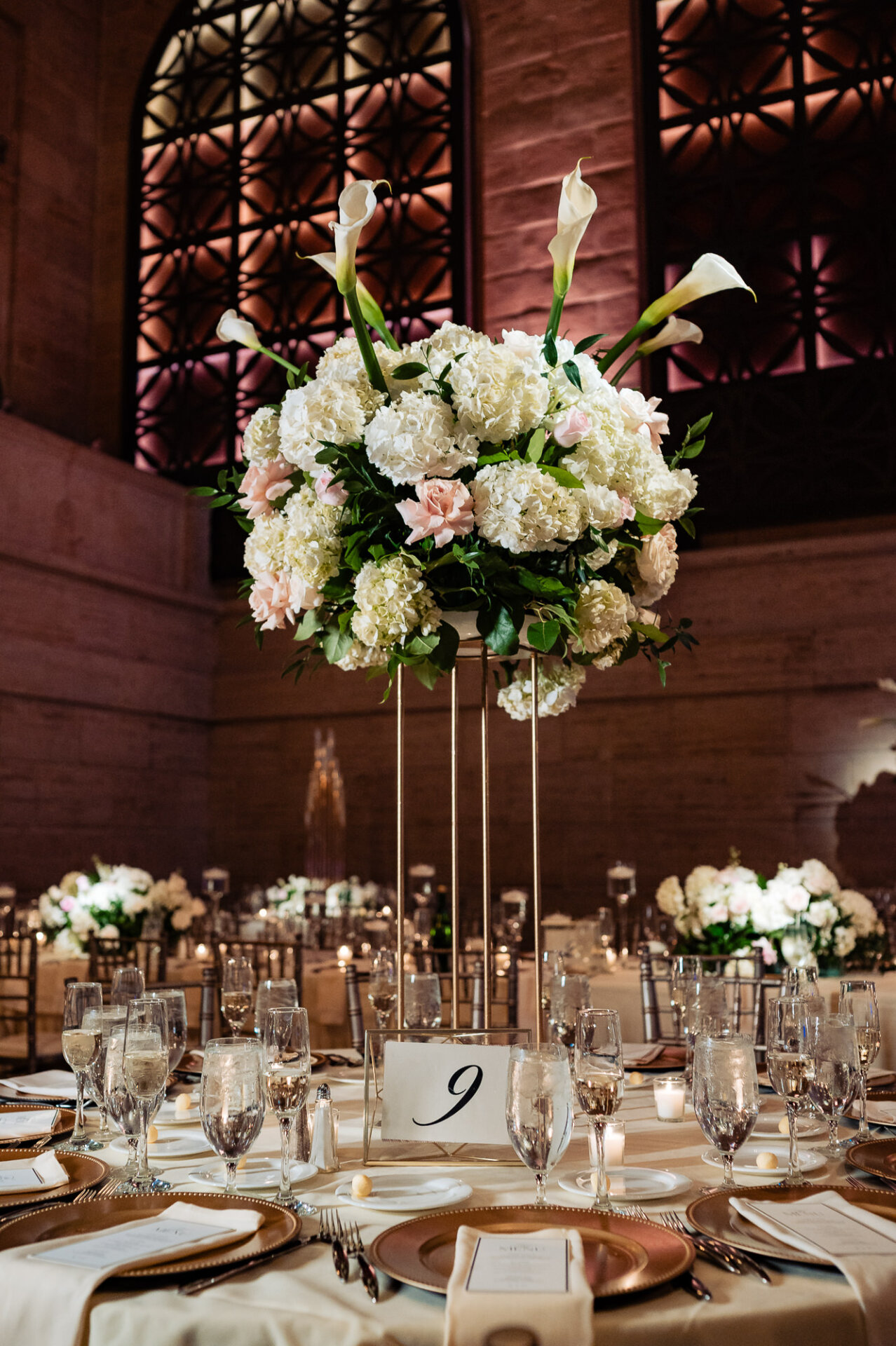 Tall floral centrepiece with white hydrangeas and calla lilies at the Union Trust reception