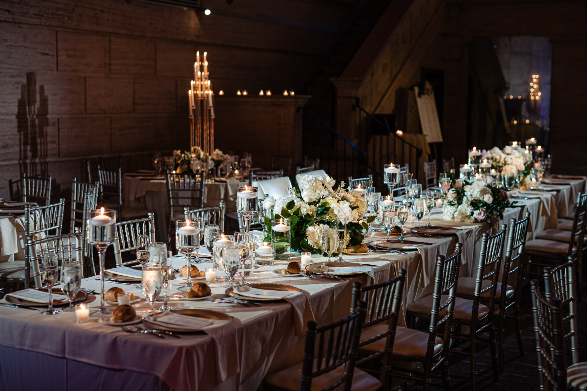 Reception table design featuring soft florals, candlelight, and classic wedding details
