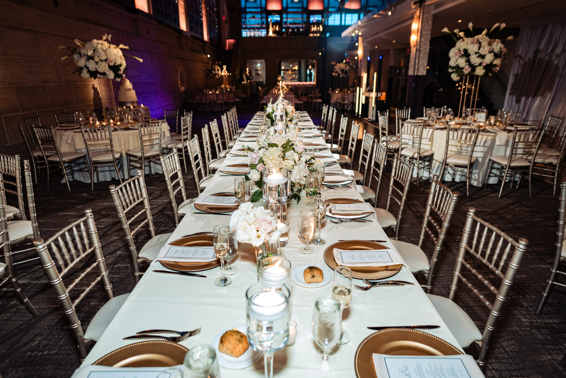 Reception table design featuring soft florals, candlelight, and classic wedding details