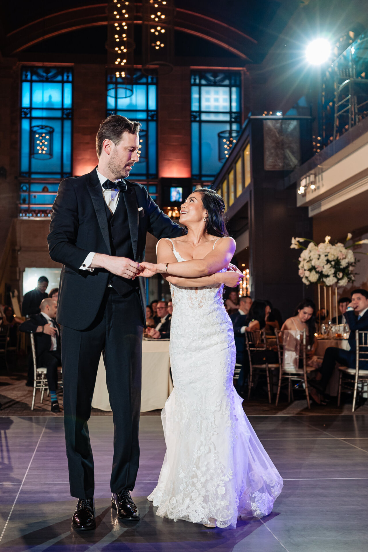 Kim and Greg’s first dance beneath the dramatic lighting of Union Trust’s reception space