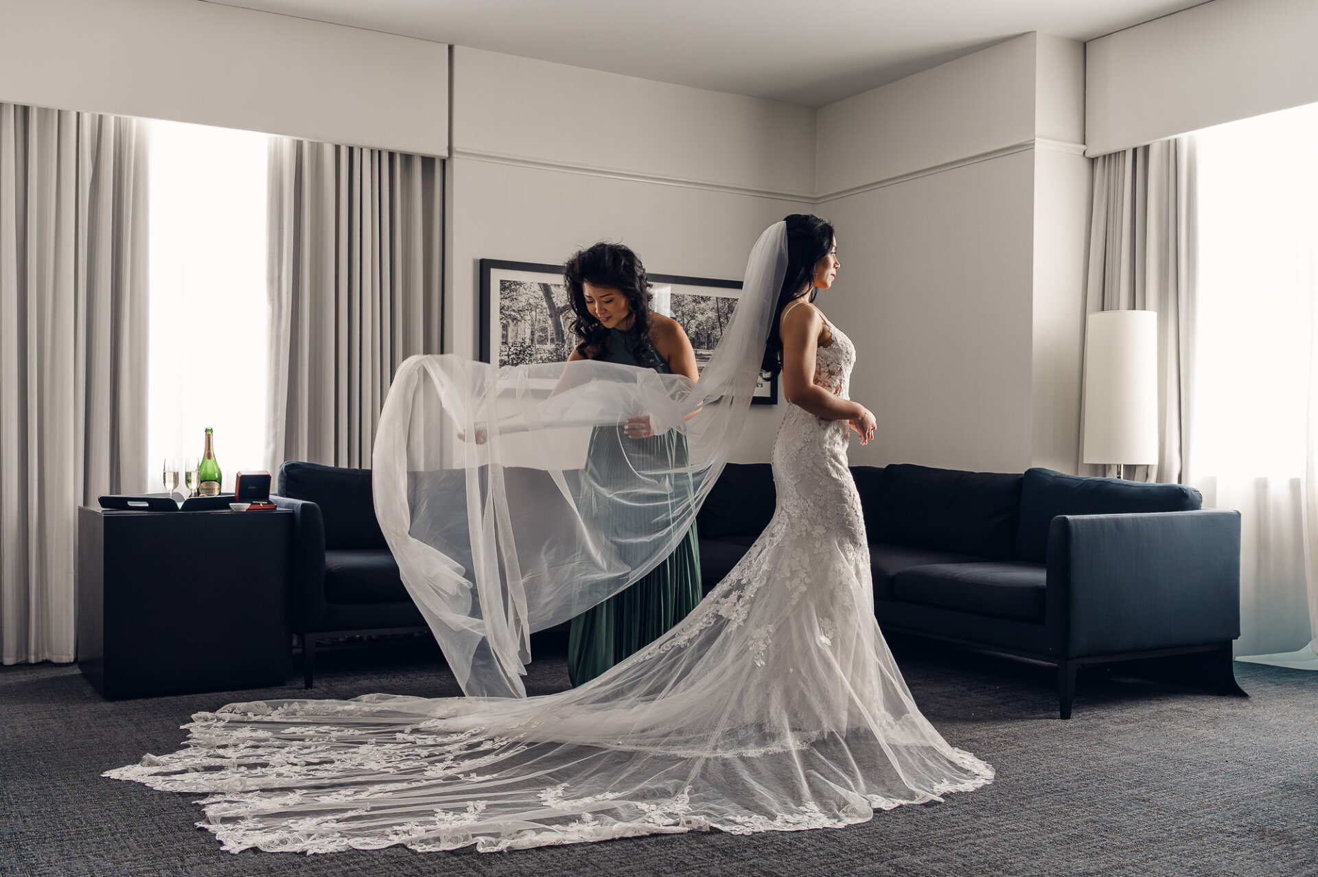 Bride getting ready with her maid of honour arranging a cathedral veil before the Union Trust wedding ceremony