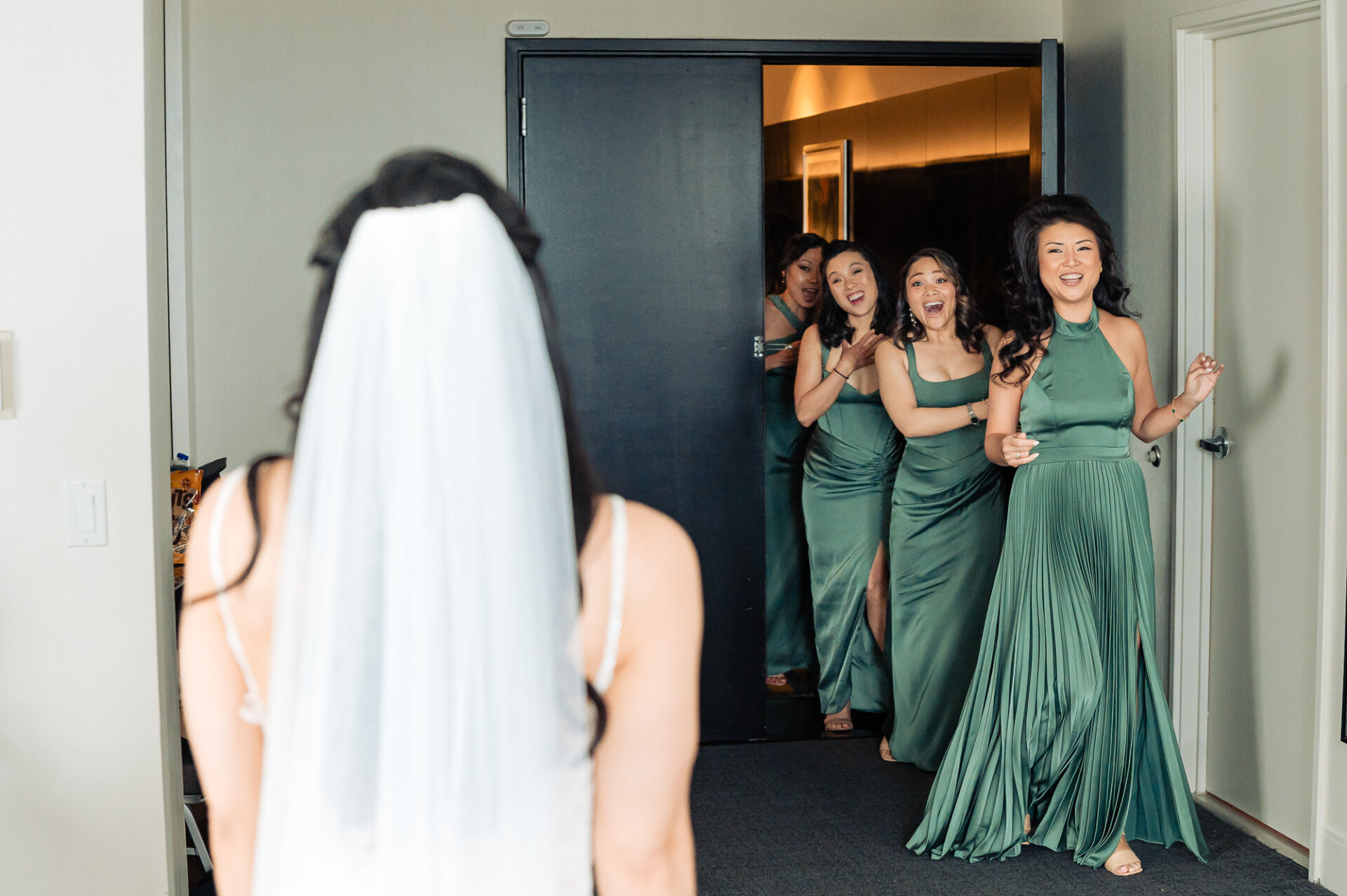 Bridesmaids’ first look reaction as they see the bride in her wedding dress for the first time