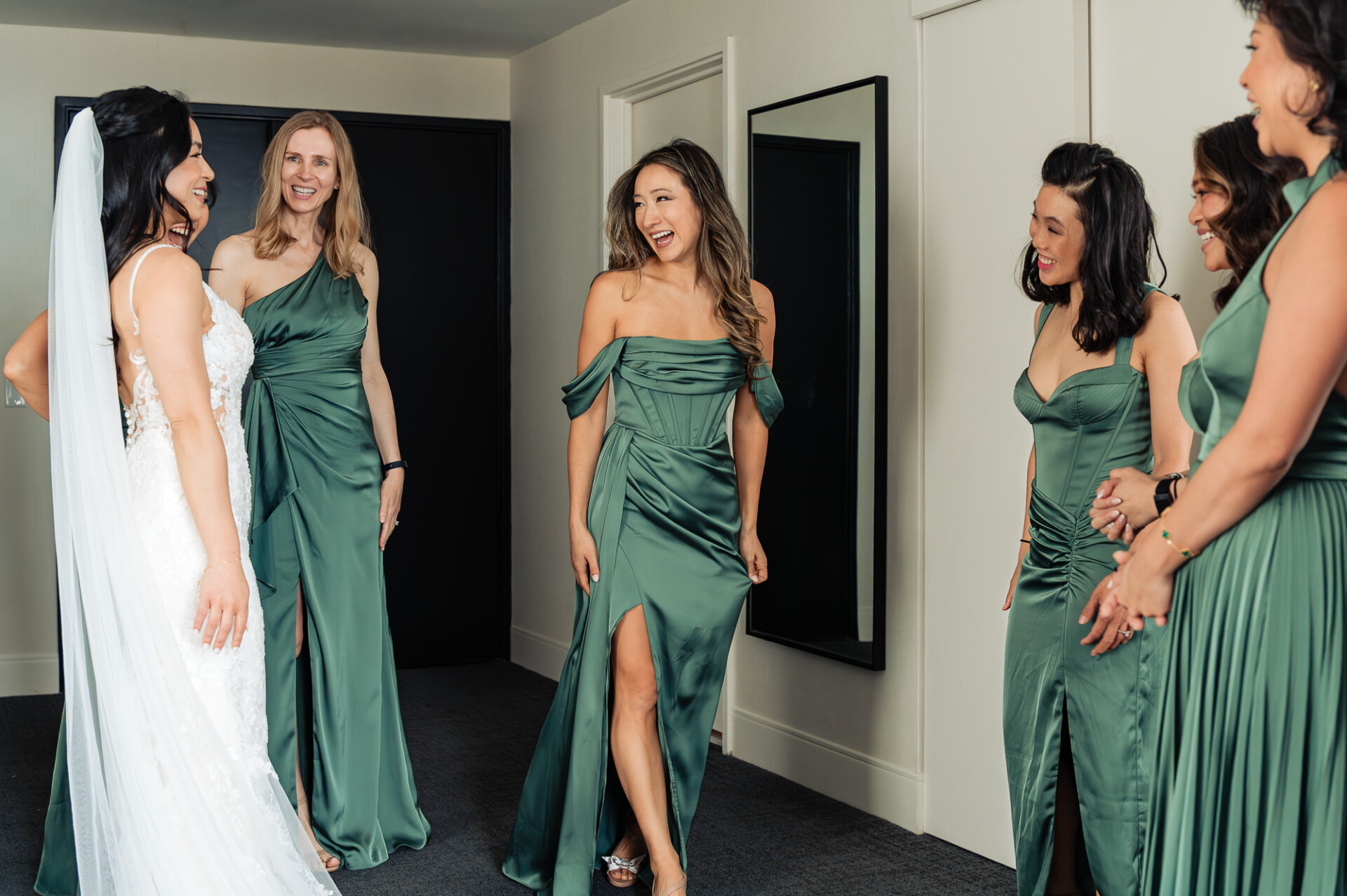 Joyful bridal suite moment shared between the bride and her bridesmaids before the ceremony
