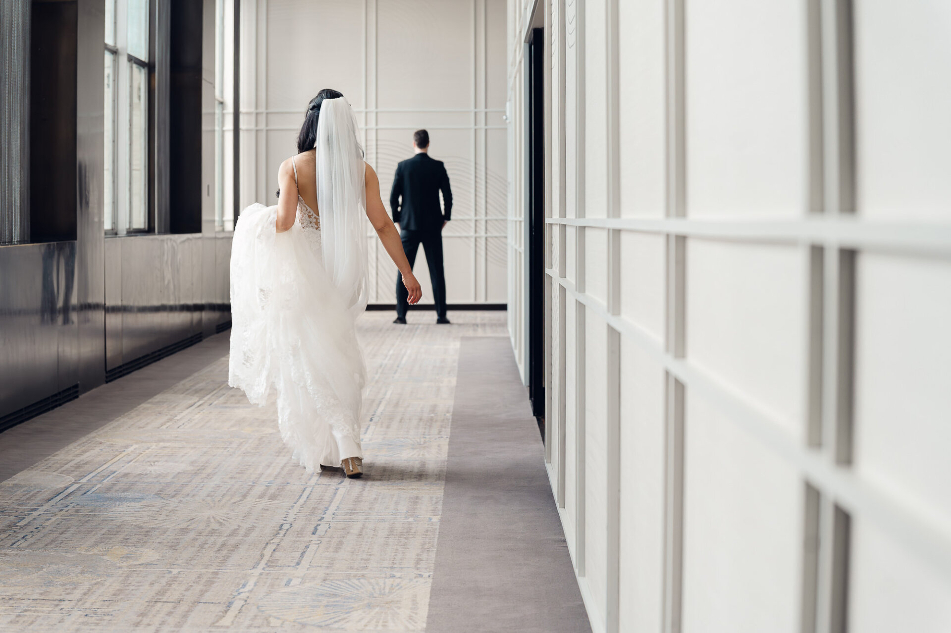 Bride walking toward her groom for an emotional first look at Union Trust in Philadelphia