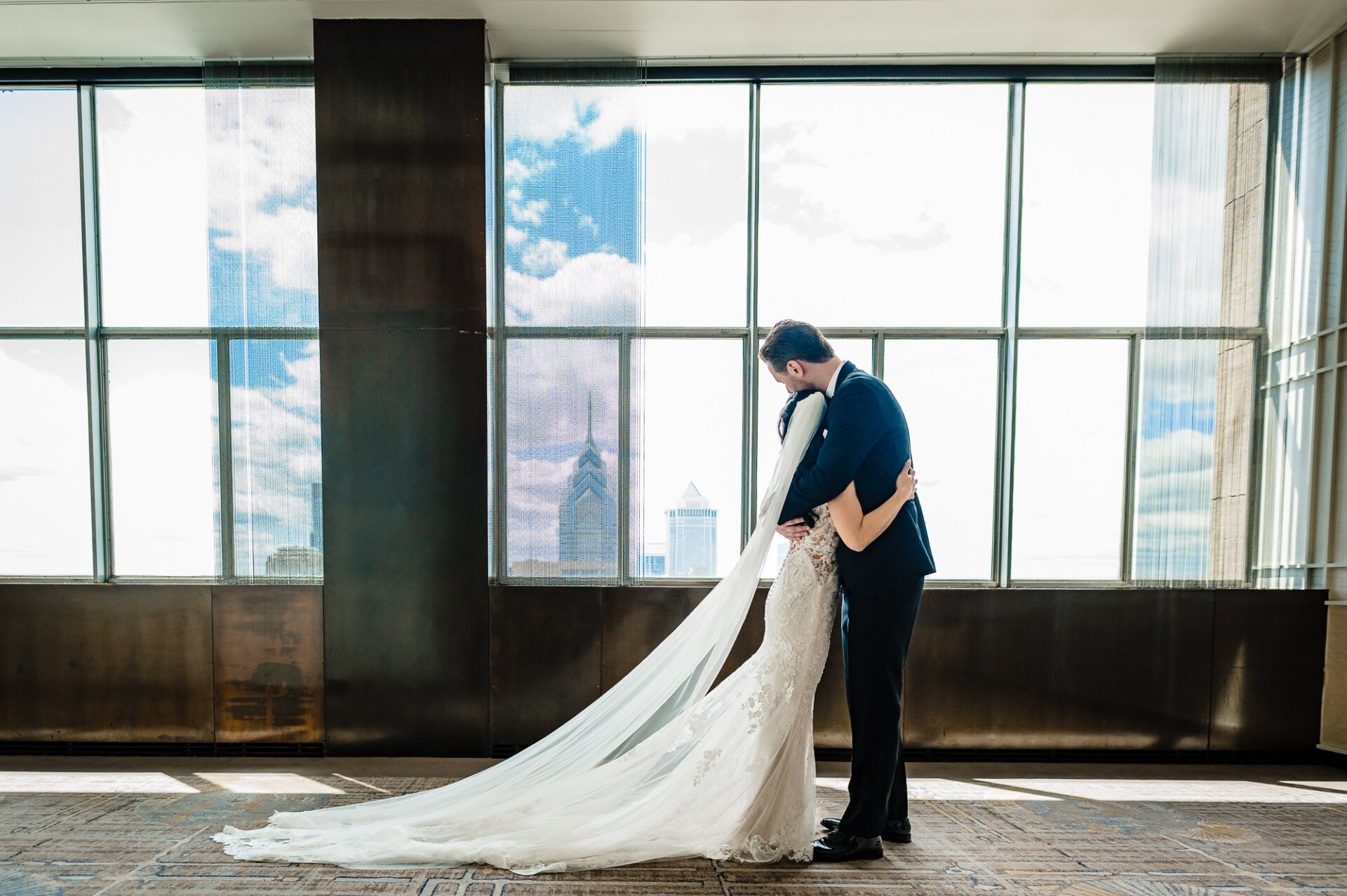 Romantic Union Trust wedding portrait with a flowing veil and Philadelphia skyline views