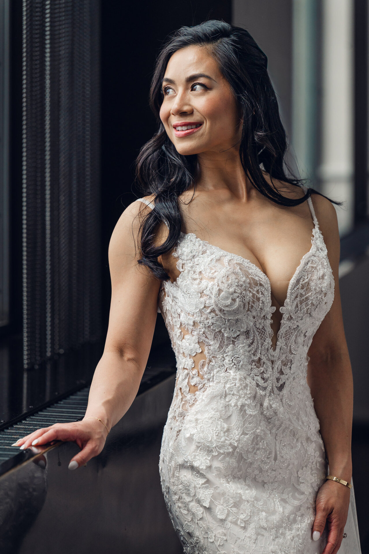 legant bridal portrait by the window showcasing intricate lace gown details and natural light
