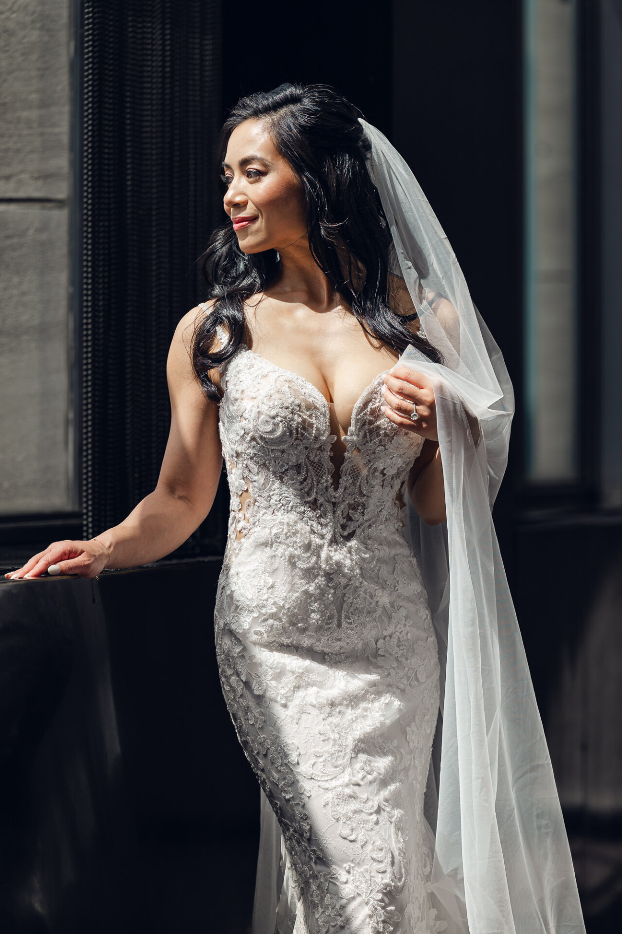 legant bridal portrait by the window showcasing intricate lace gown details and natural light