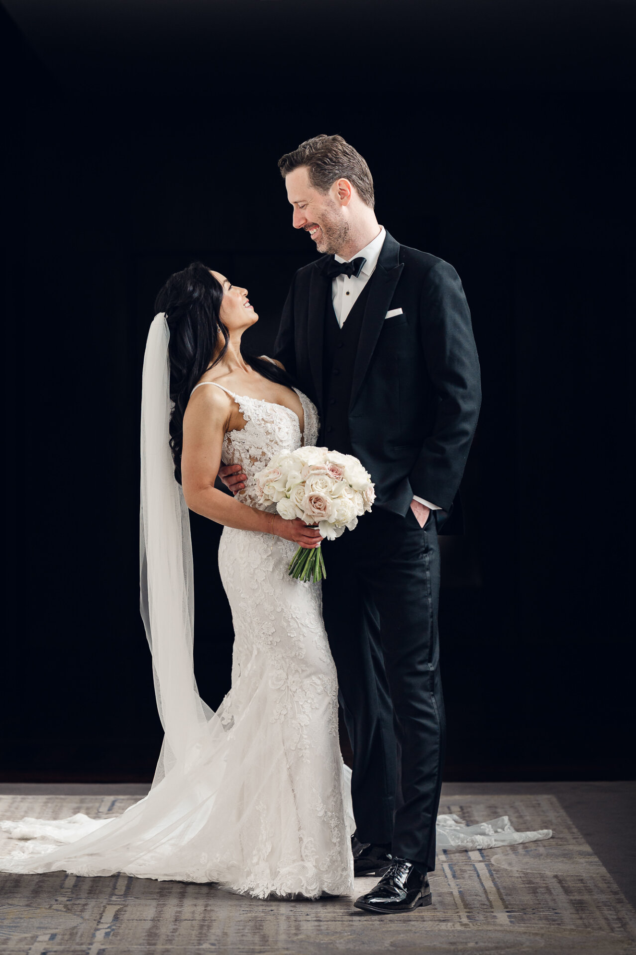 Formal wedding portrait of Kim and Greg showcasing timeless black-tie style