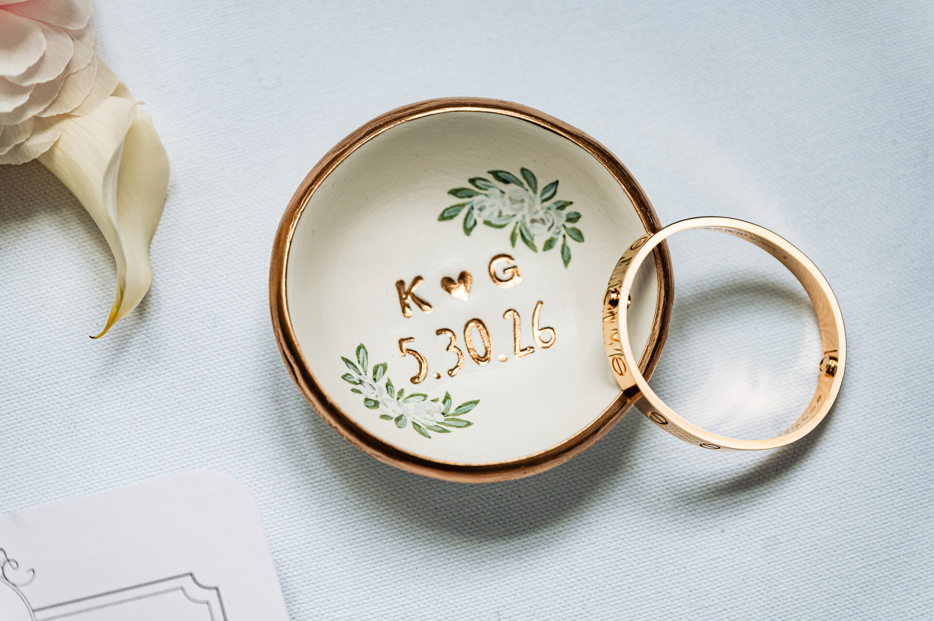Custom wedding ring dish engraved with the couple’s initials and wedding date