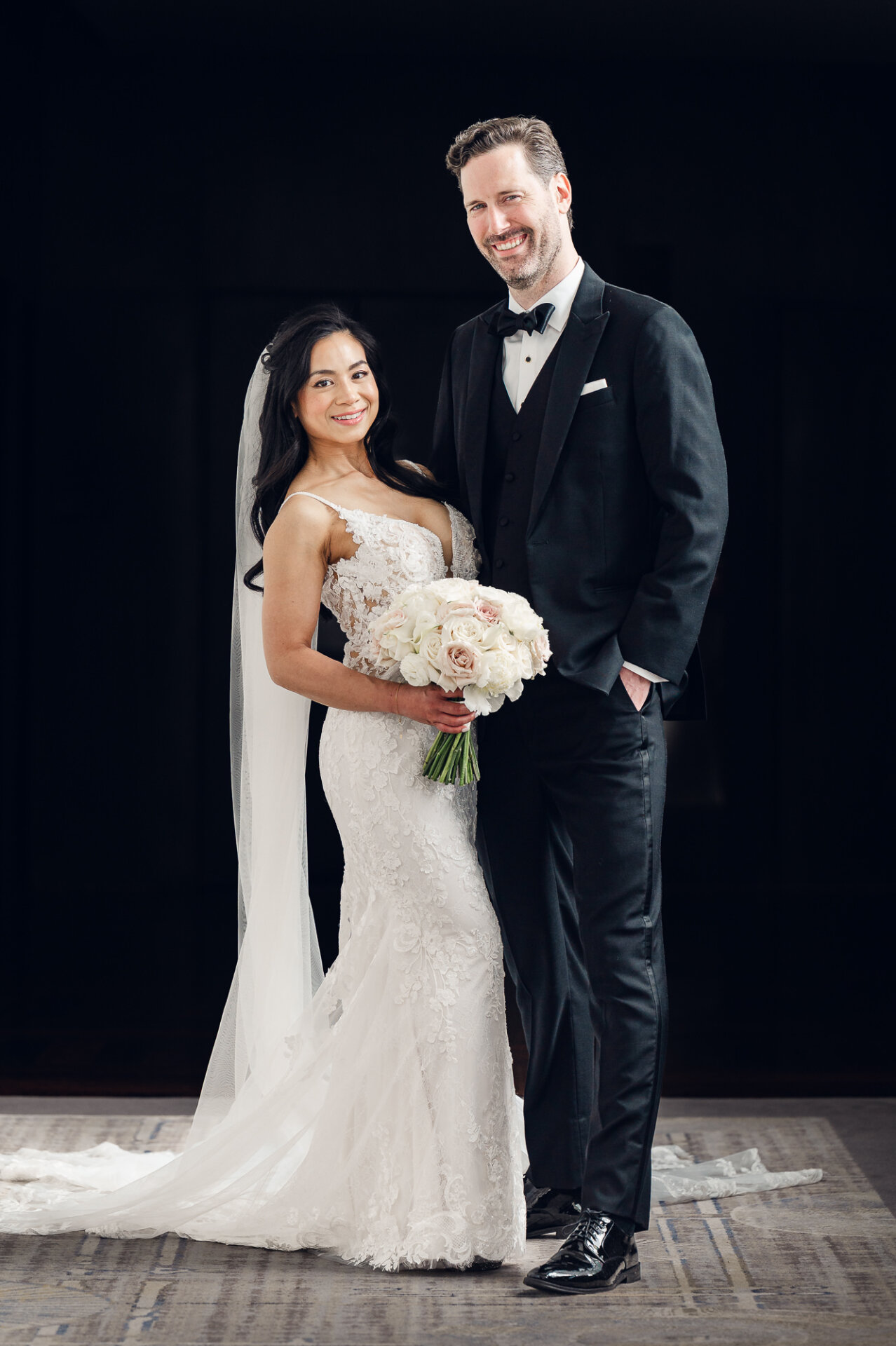 Formal wedding portrait of Kim and Greg showcasing timeless black-tie style