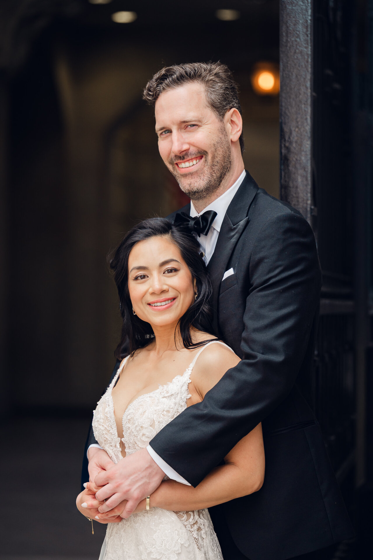 Joyful newlywed portrait capturing genuine smiles outside Union Trust in Philadelphia