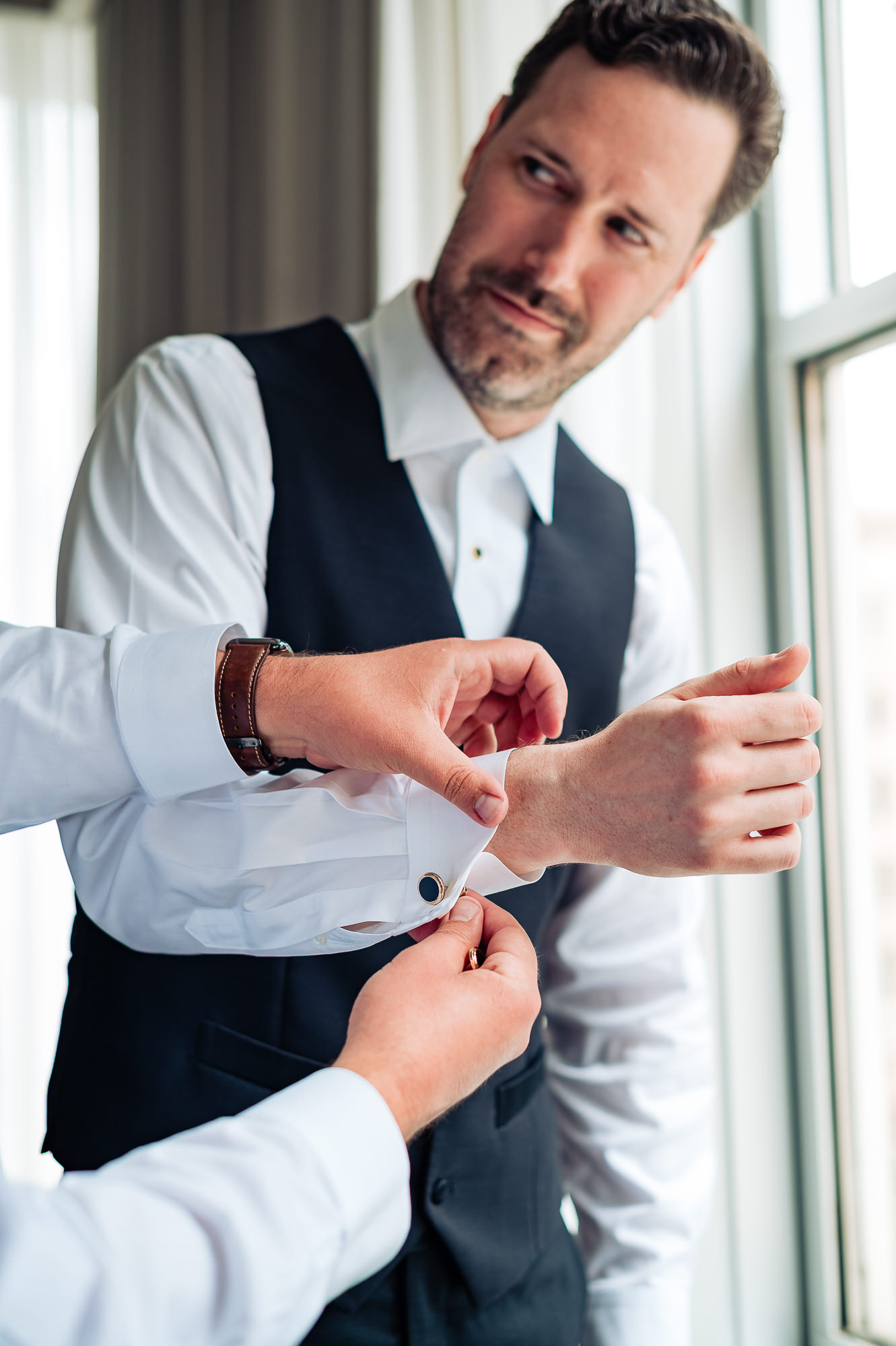 Groom getting ready as cufflinks are fastened before the Union Trust wedding ceremony