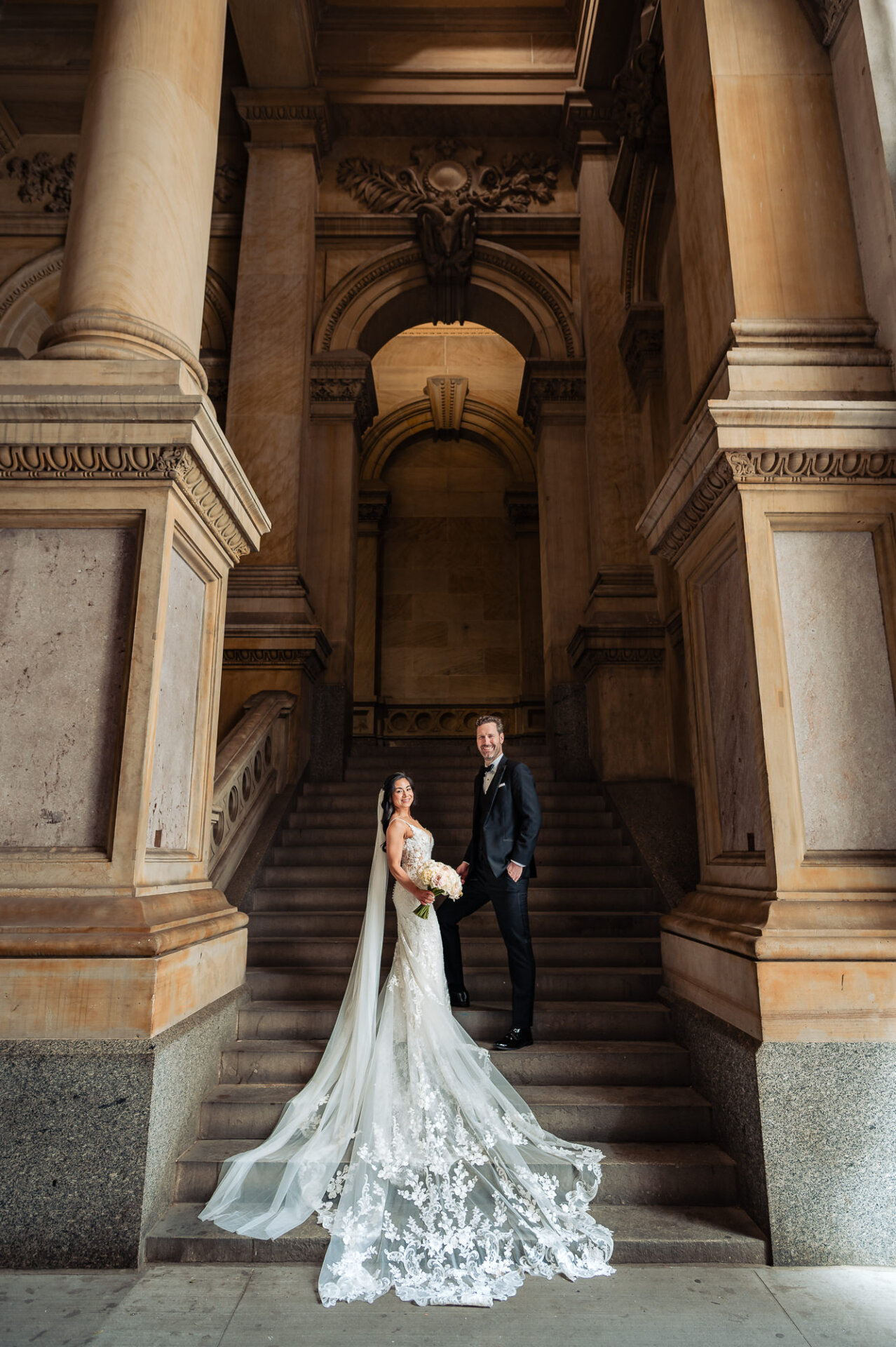 Editorial wedding portrait on the staircase showcasing Union Trust’s historic architecture