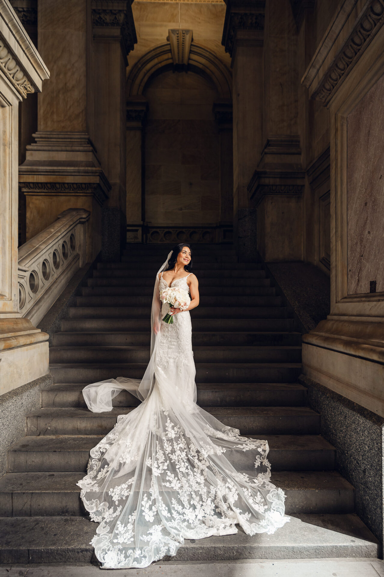 Bridal portrait on Union Trust’s grand staircase highlighting a dramatic cathedral-length veil