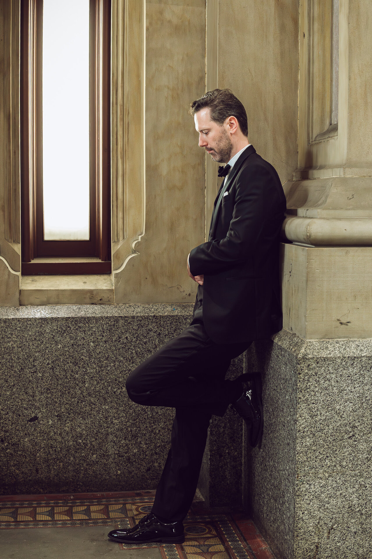 Classic groom portrait framed by Union Trust’s grand architecture and window light