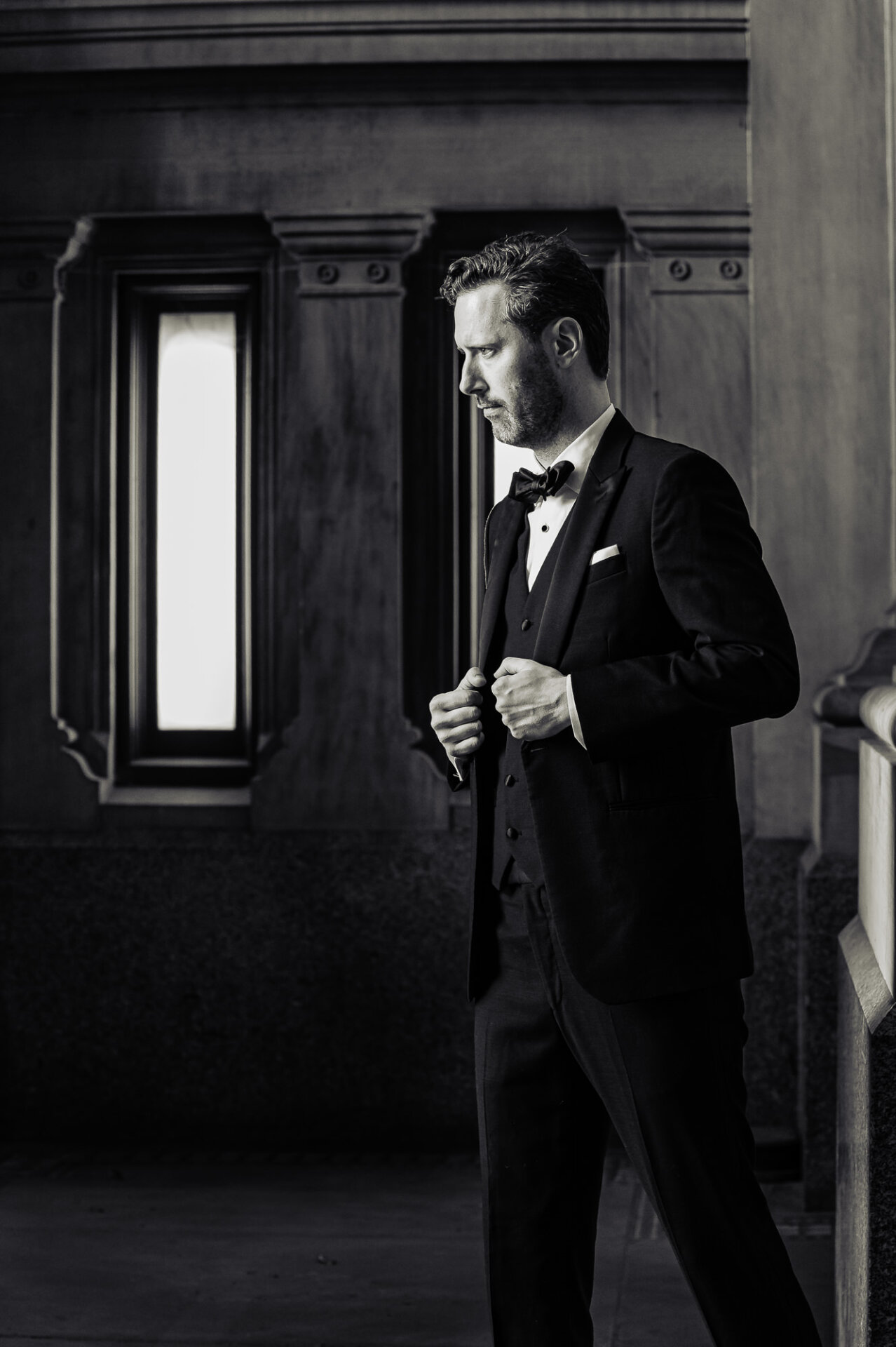 Classic groom portrait framed by Union Trust’s grand architecture and window light