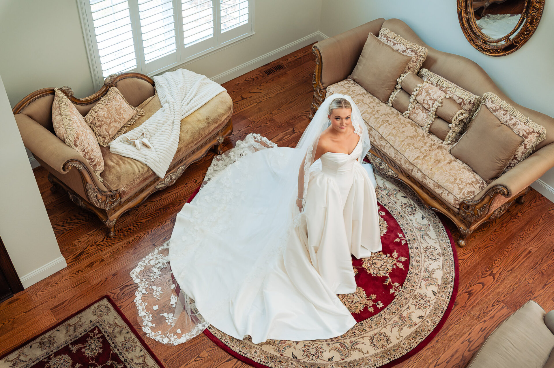 Overhead bridal portrait showcasing the bride’s full wedding gown and long lace veil
