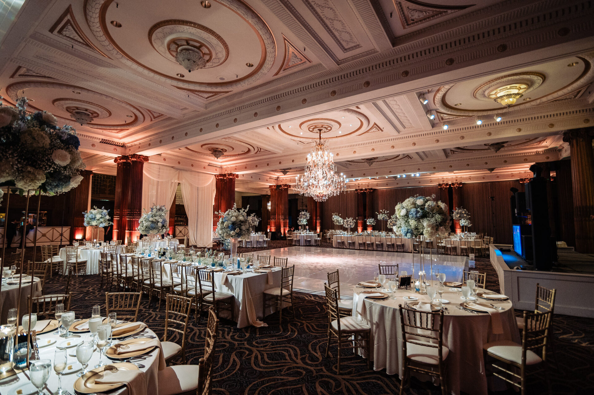 Grand Crystal Tea Room wedding reception with chandeliers, floral centerpieces, and a spacious dance floor