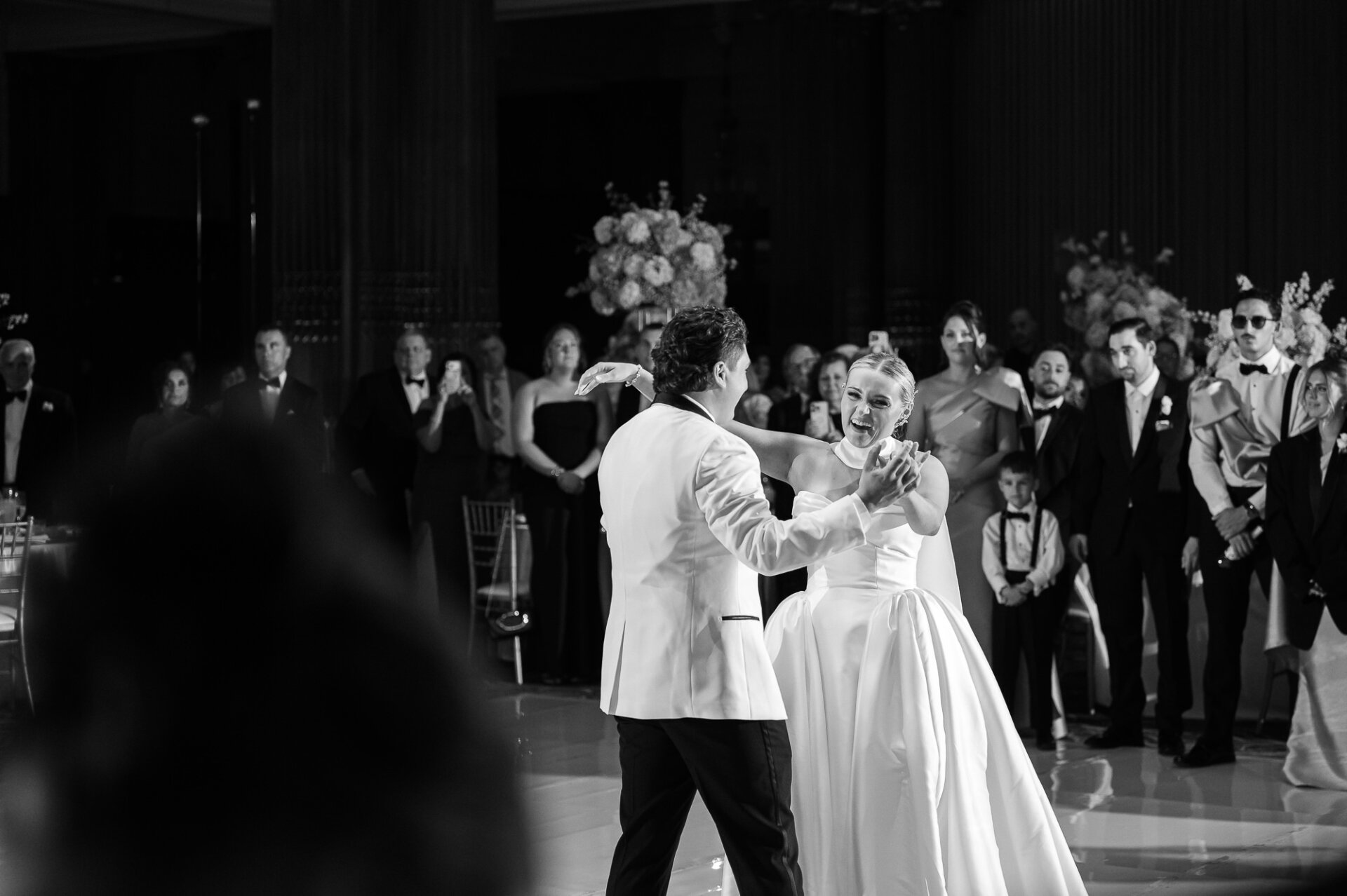 Bride and groom sharing their first dance surrounded by guests at the Crystal Tea Room