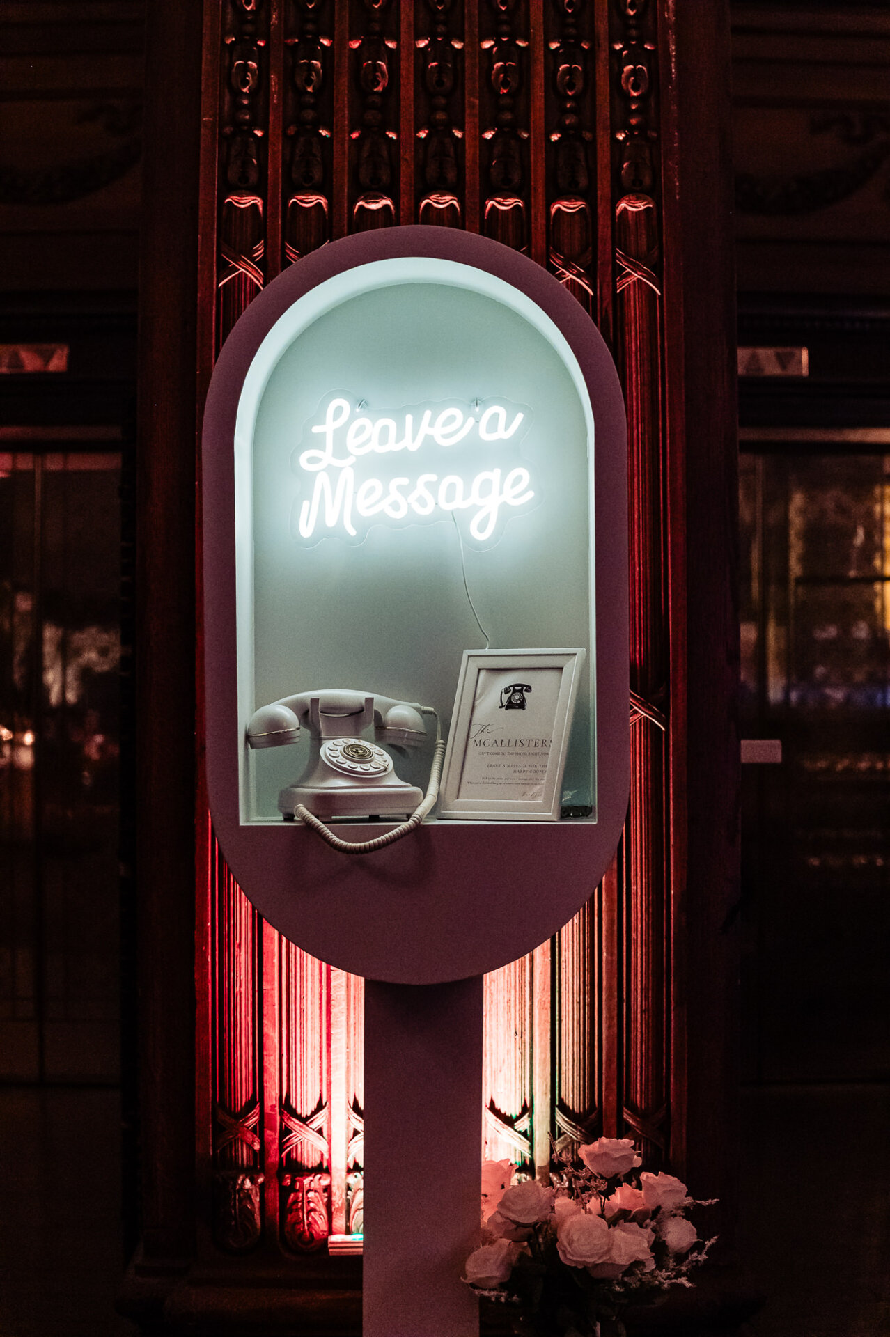 Wedding audio guest book station with vintage telephone and glowing “Leave a Message” sign