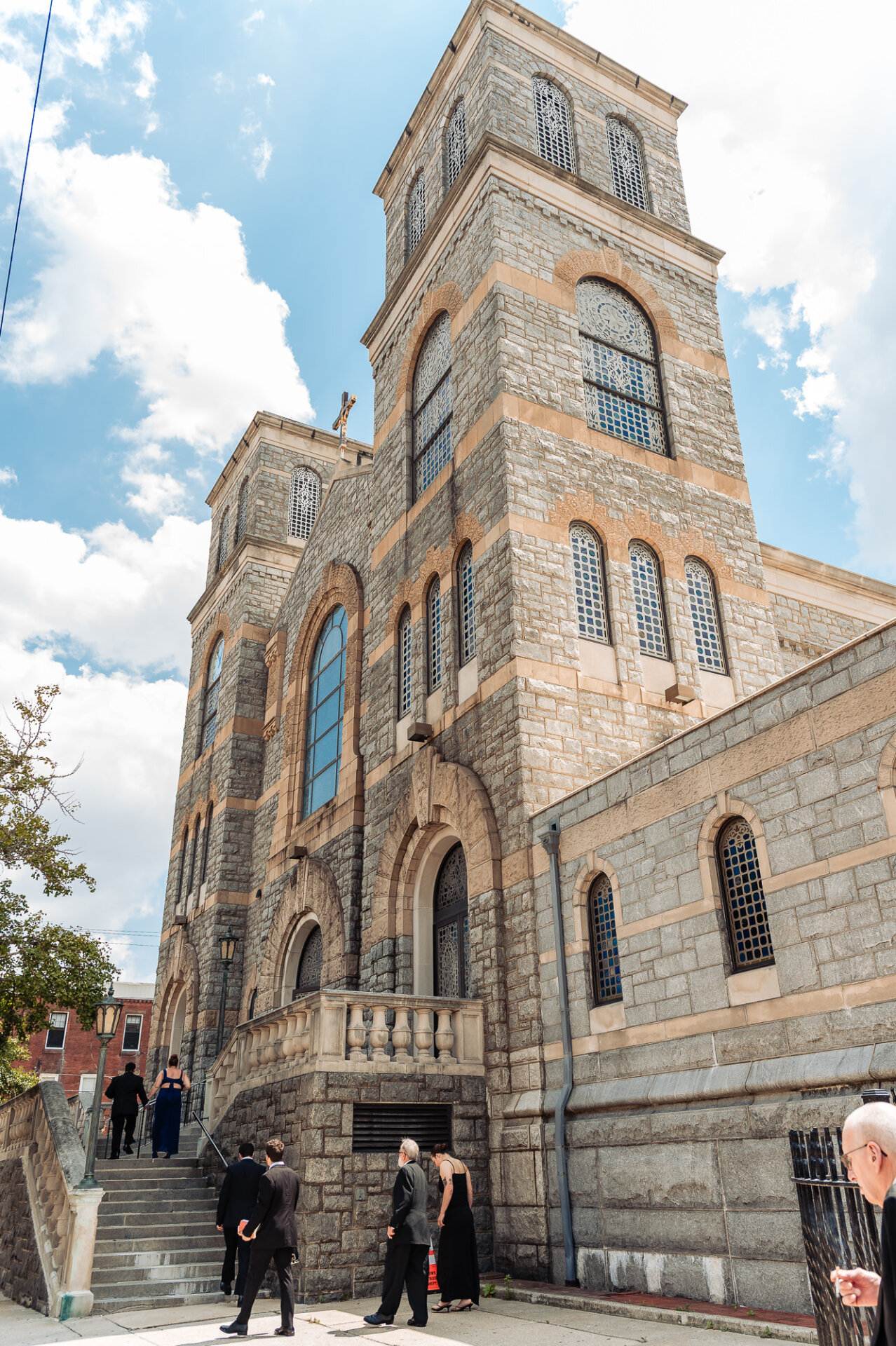 Exterior view of the stone Catholic church on a sunny wedding day in Philadelphia