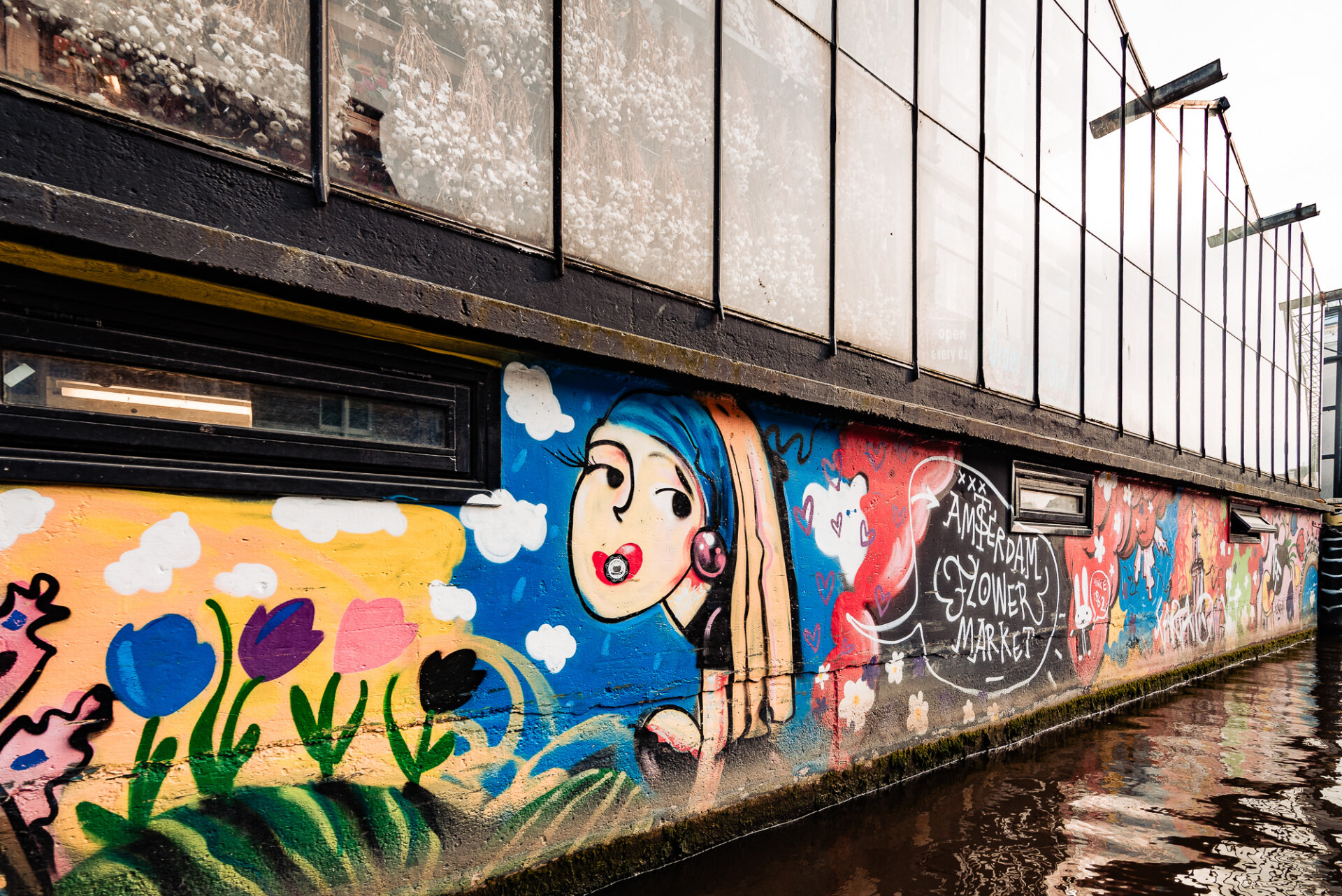281. Colourful street art and tulip murals decorating the exterior of Amsterdam’s IJ-Hallen market