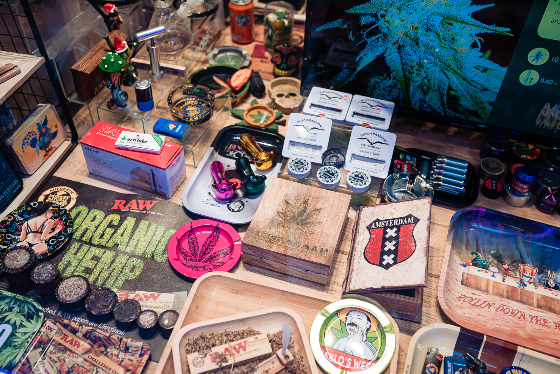 Amsterdam shop display featuring cannabis-themed souvenirs, rolling papers and smoking accessories