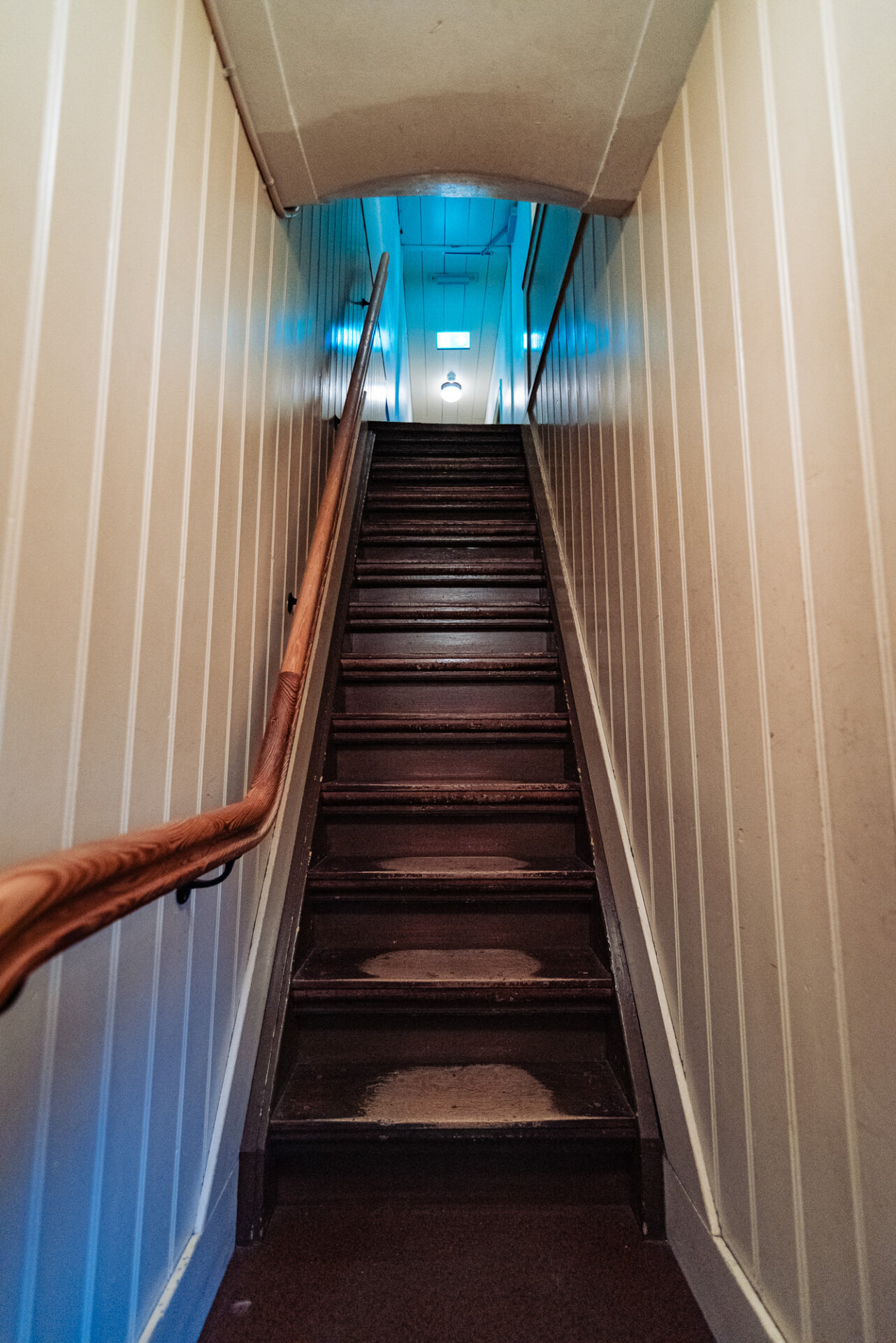 Steep narrow staircase inside a historic Amsterdam building with traditional wooden steps