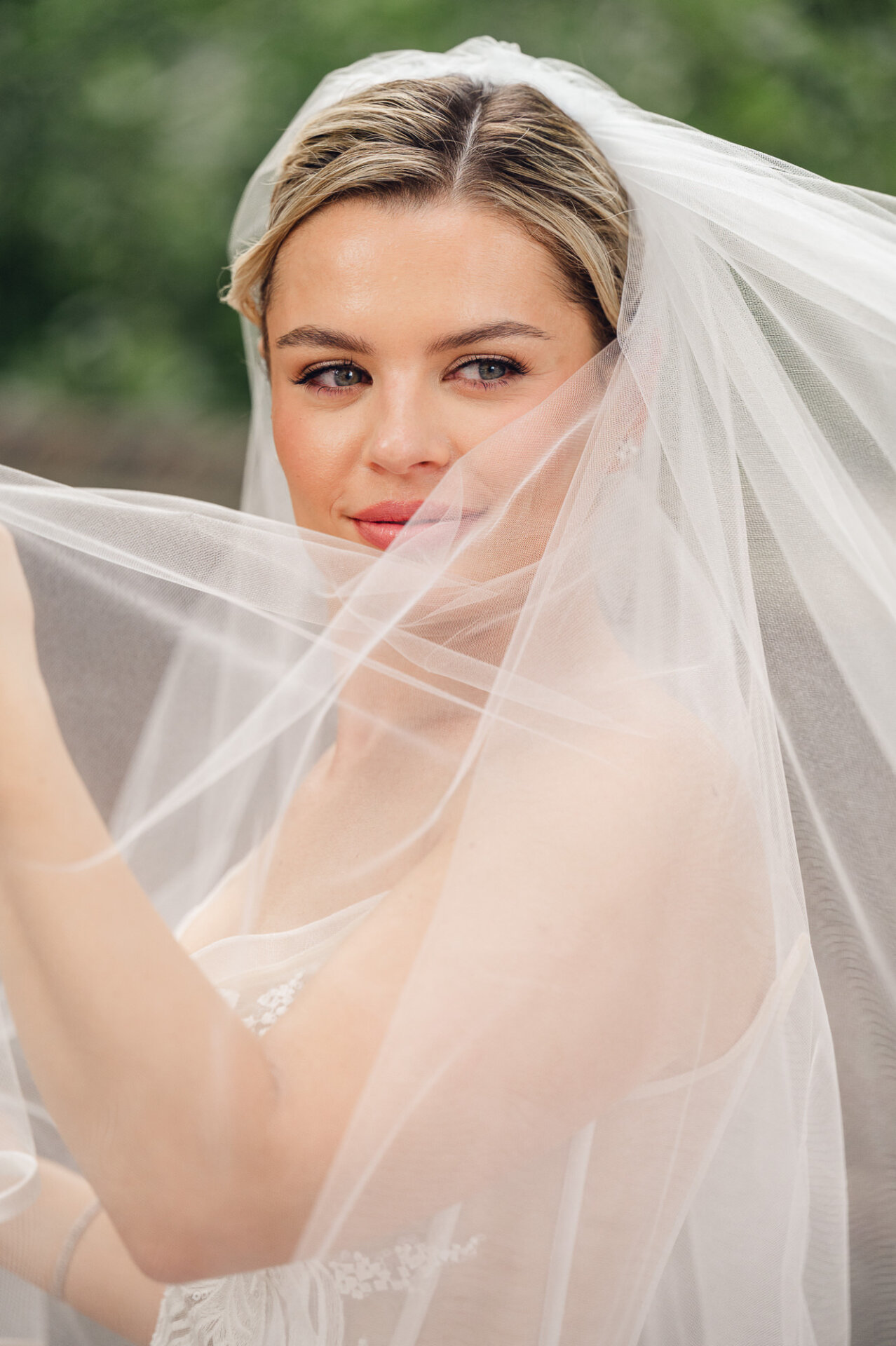 Close-up bridal portrait framed by a sheer veil during a wedding in Philadelphia.