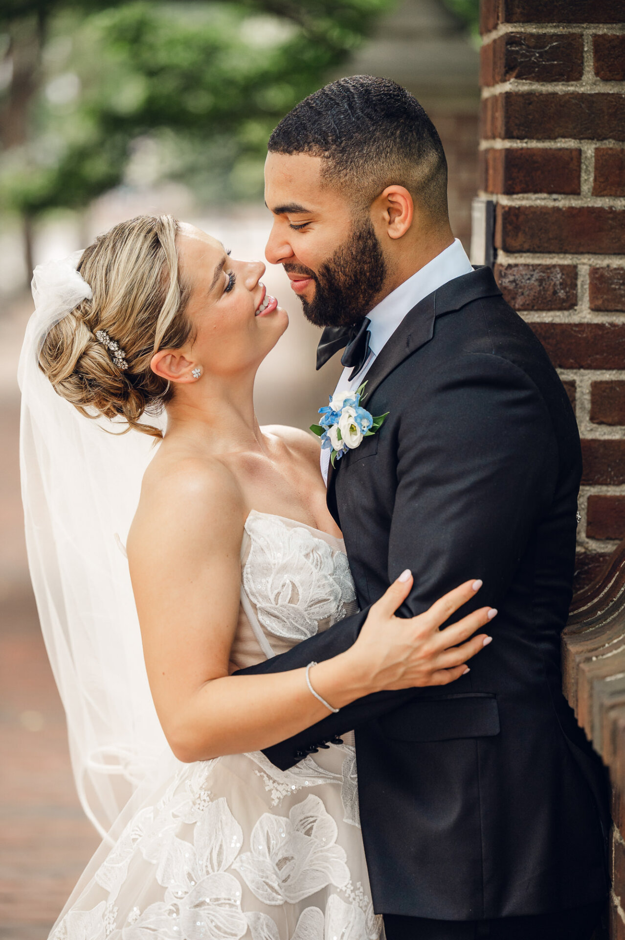 Bride and groom share an affectionate moment during their Philadelphia wedding portraits.