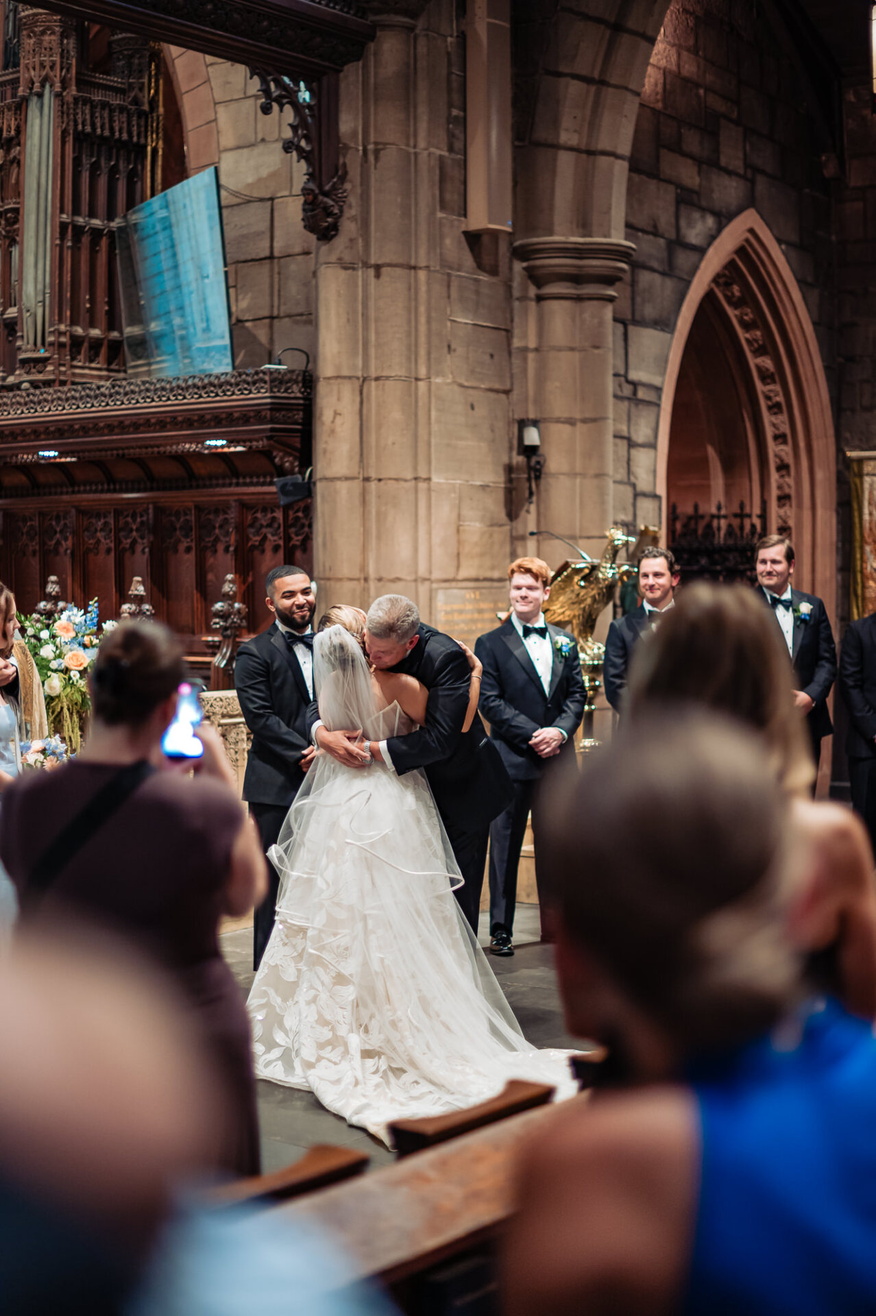 Bride receives an emotional kiss from her father at the Saint Mark’s Church altar.